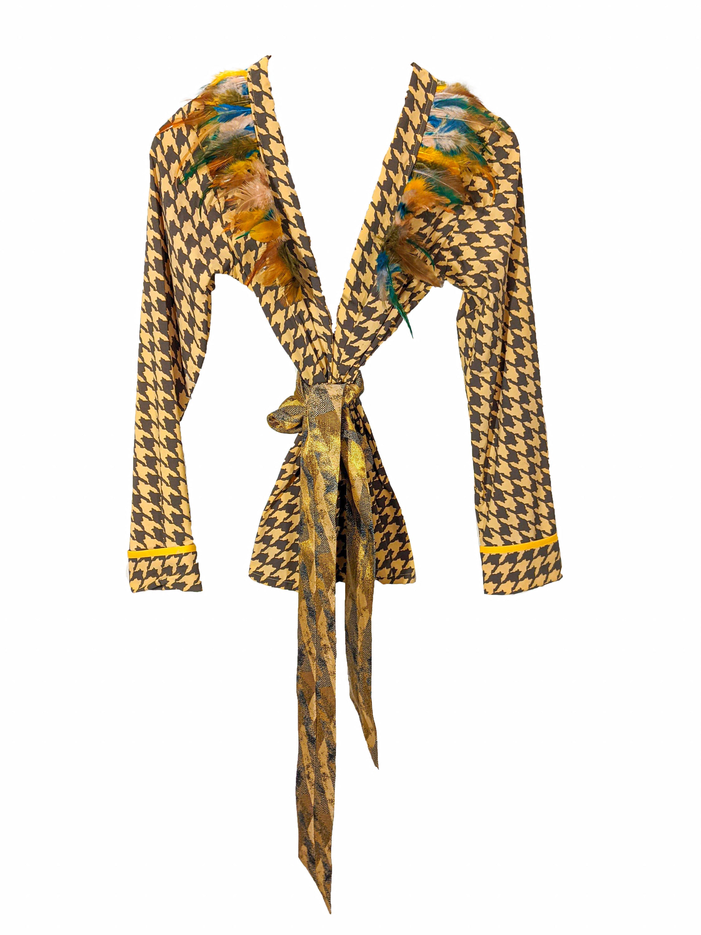 LAGINA jacket and pants suit featuring houndstooth pattern in yellow and tile brown, adorned with colorful feathers and shiny golden waistband.