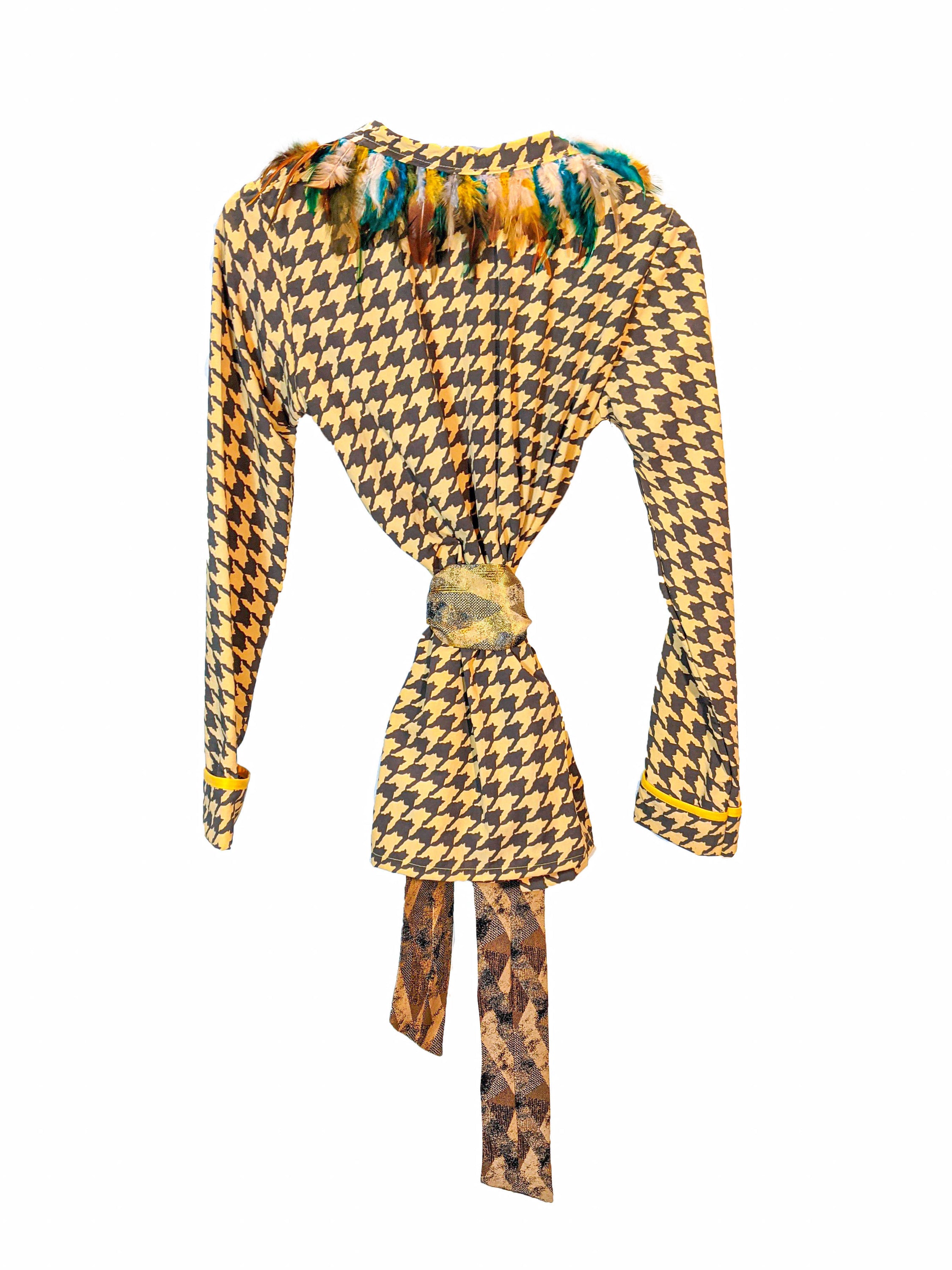 LAGINA jacket and pants suit featuring houndstooth pattern in yellow and tile brown, adorned with colorful feathers and shiny golden waistband.