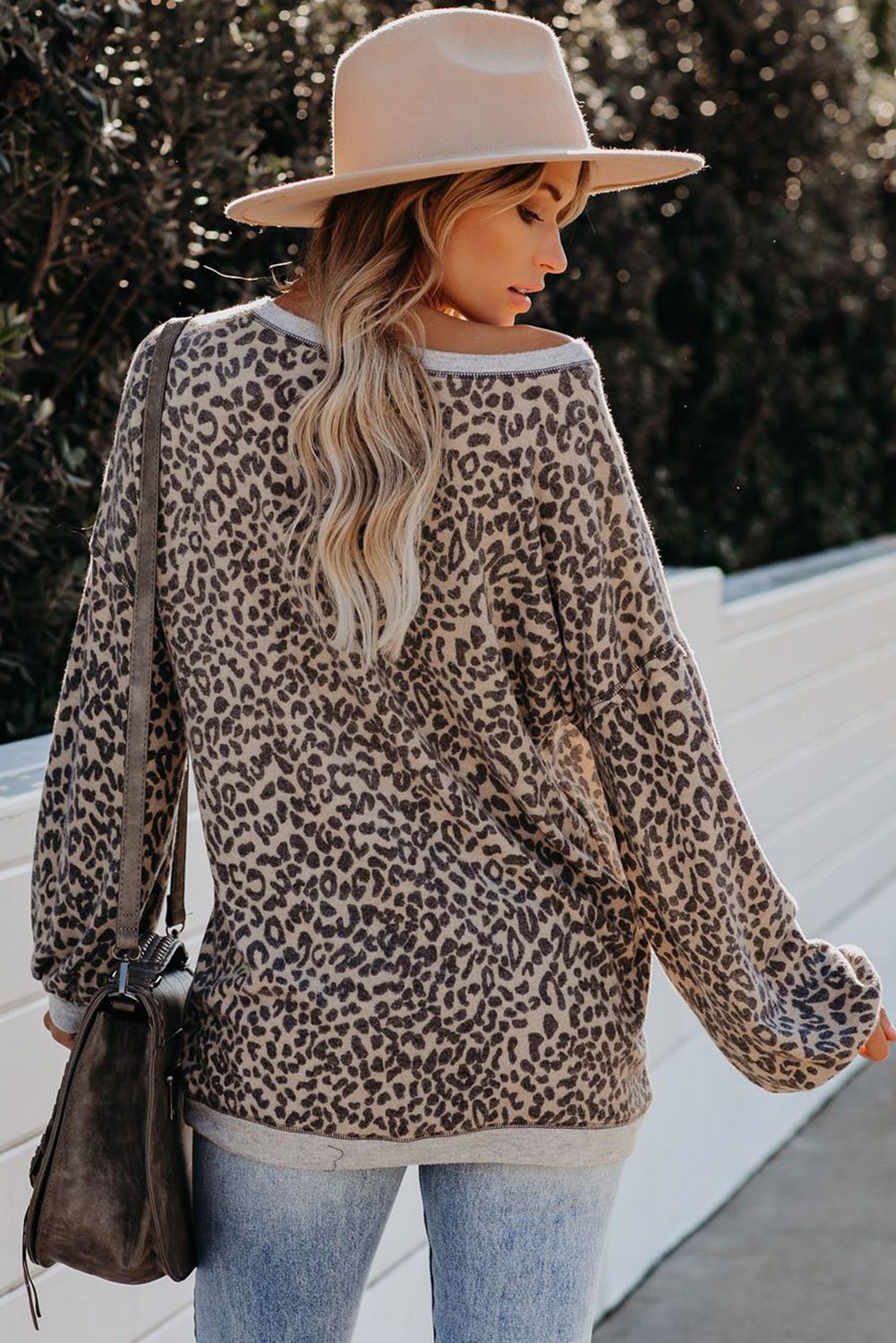 A stylish Lantern Sleeve Knitted Sweatshirt featuring a chic leopard print design, wide neckline, and relaxed fit, perfect for casual wear.