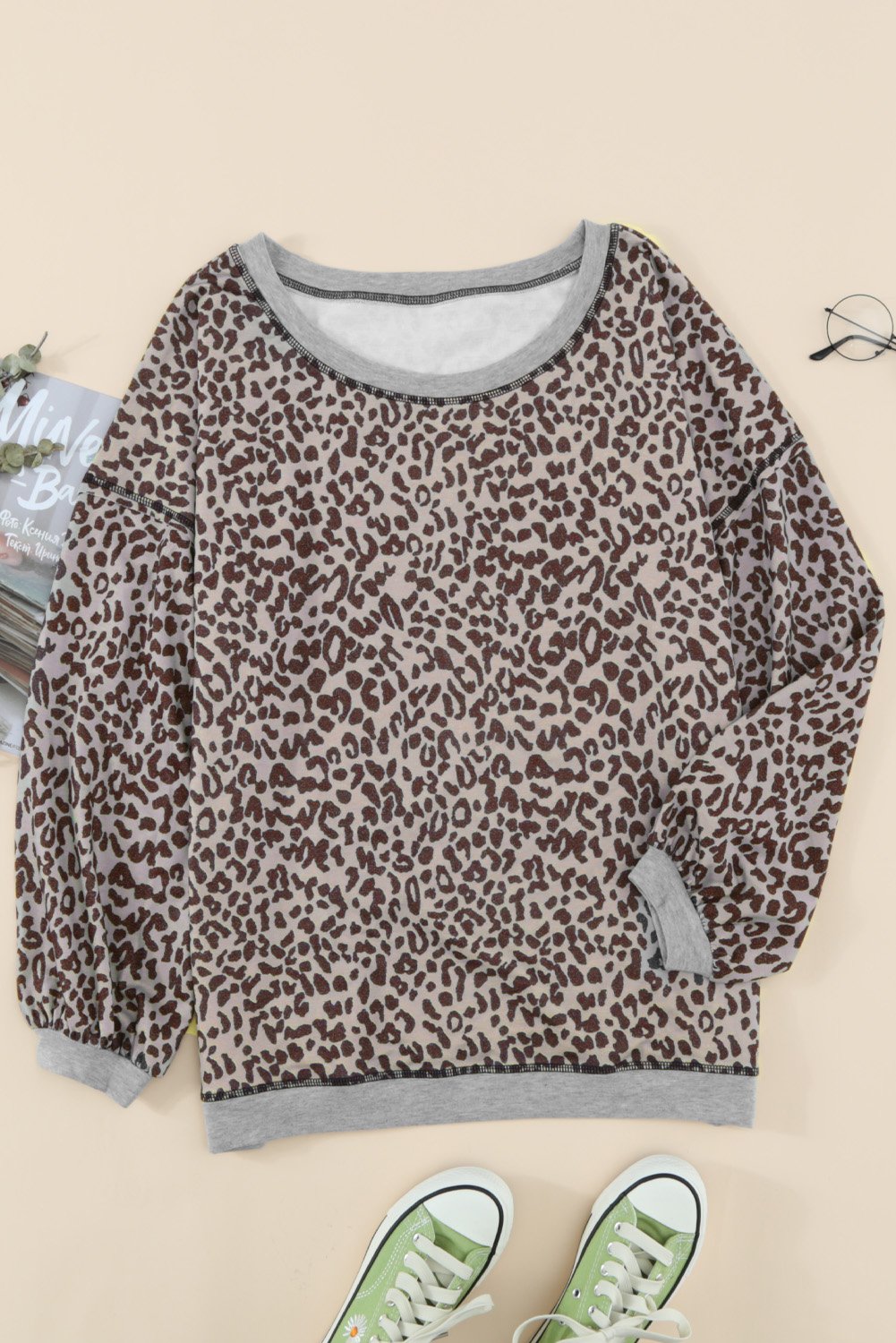 A stylish Lantern Sleeve Knitted Sweatshirt featuring a chic leopard print design, wide neckline, and relaxed fit, perfect for casual wear.