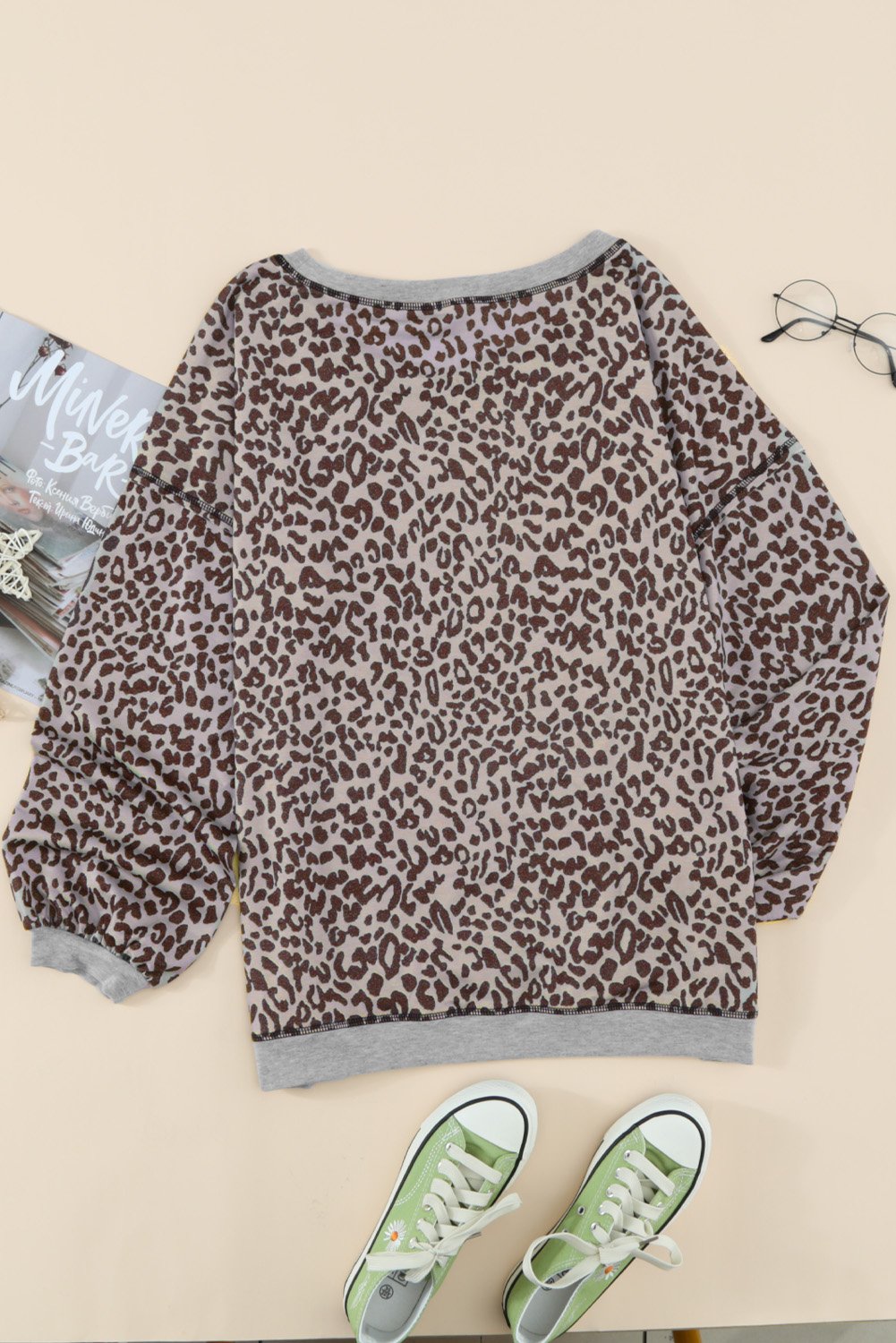 A stylish Lantern Sleeve Knitted Sweatshirt featuring a chic leopard print design, wide neckline, and relaxed fit, perfect for casual wear.