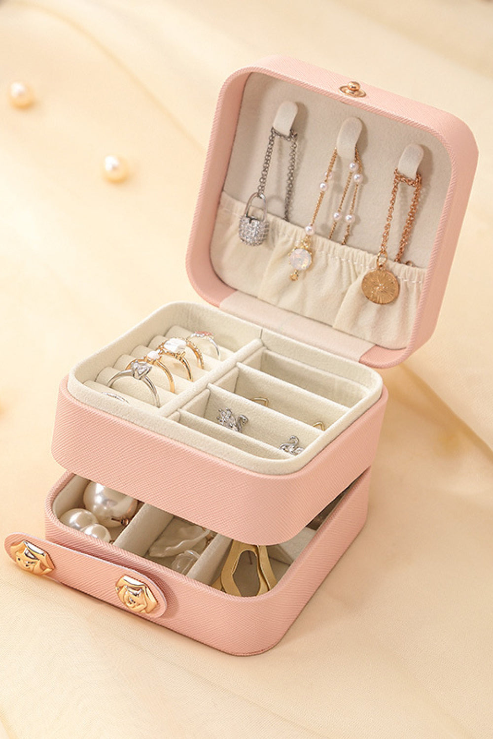 Layered Jewelry Storage Box made from durable PU material, featuring a stylish design and compact size for organizing jewelry.