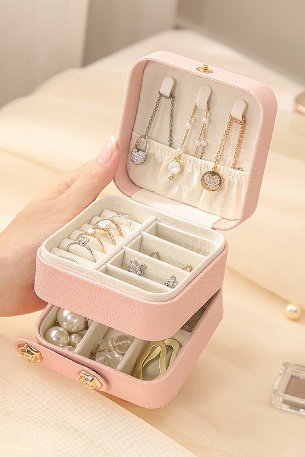 Layered Jewelry Storage Box made from durable PU material, featuring a stylish design and compact size for organizing jewelry.