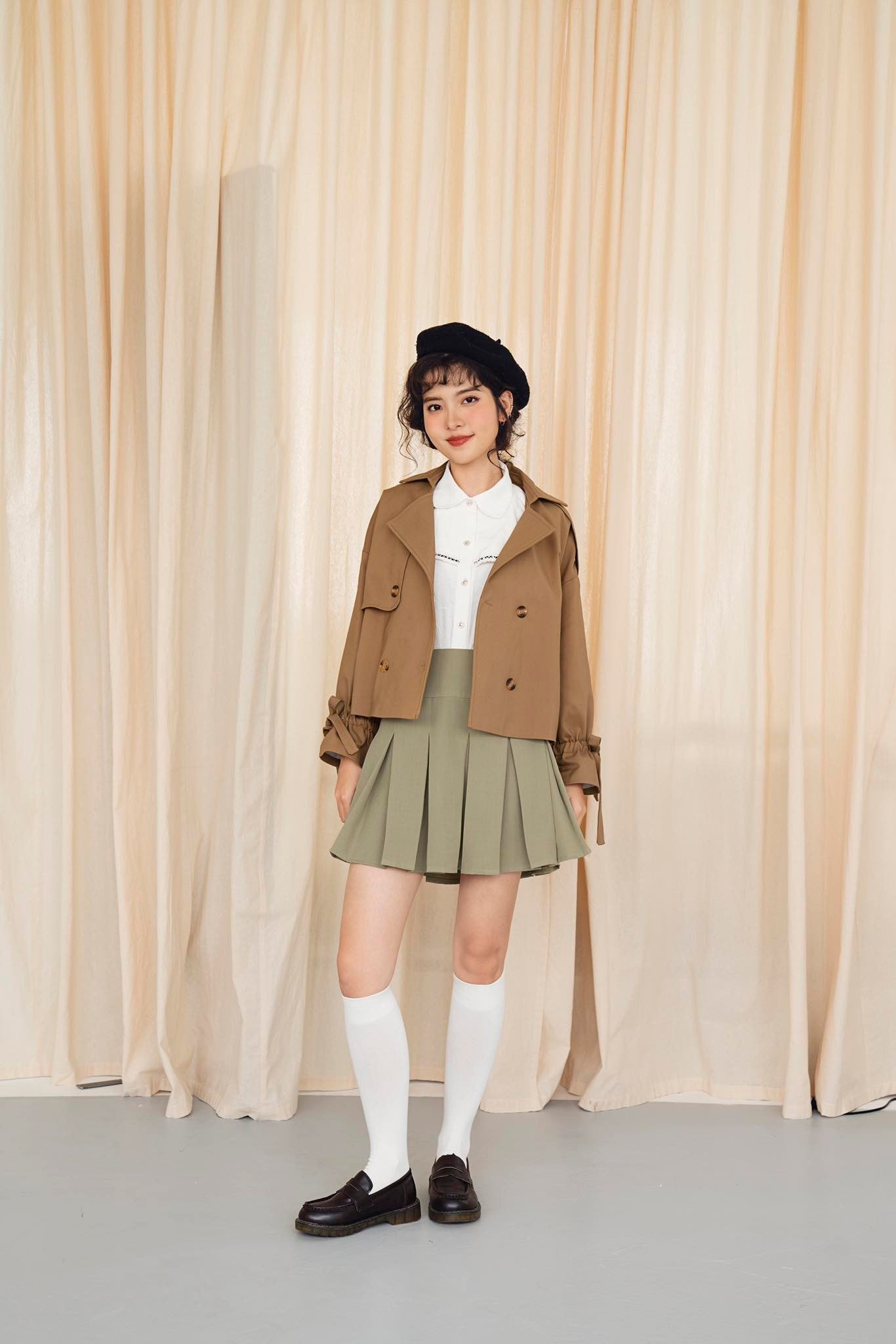 Layla Cropped Trenchcoat in khaki leather, showcasing its stylish cropped design and smooth surface.