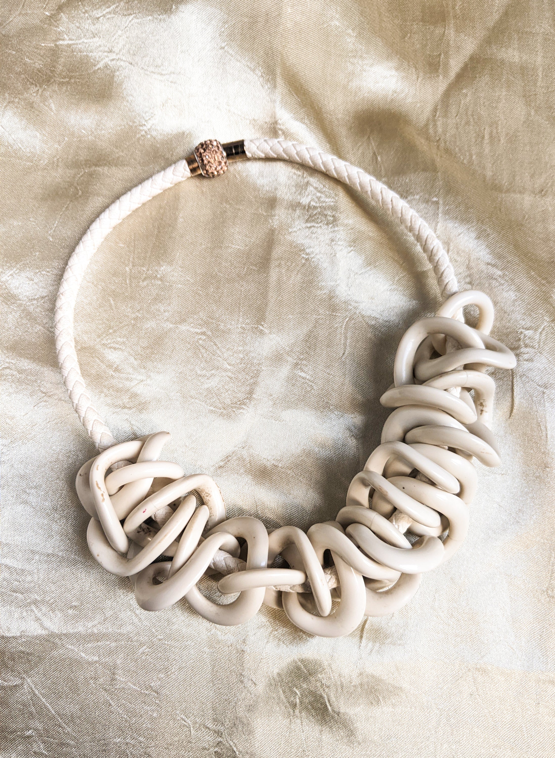 Leather knit choker featuring decorative bone loops, showcasing a stylish and unique design.