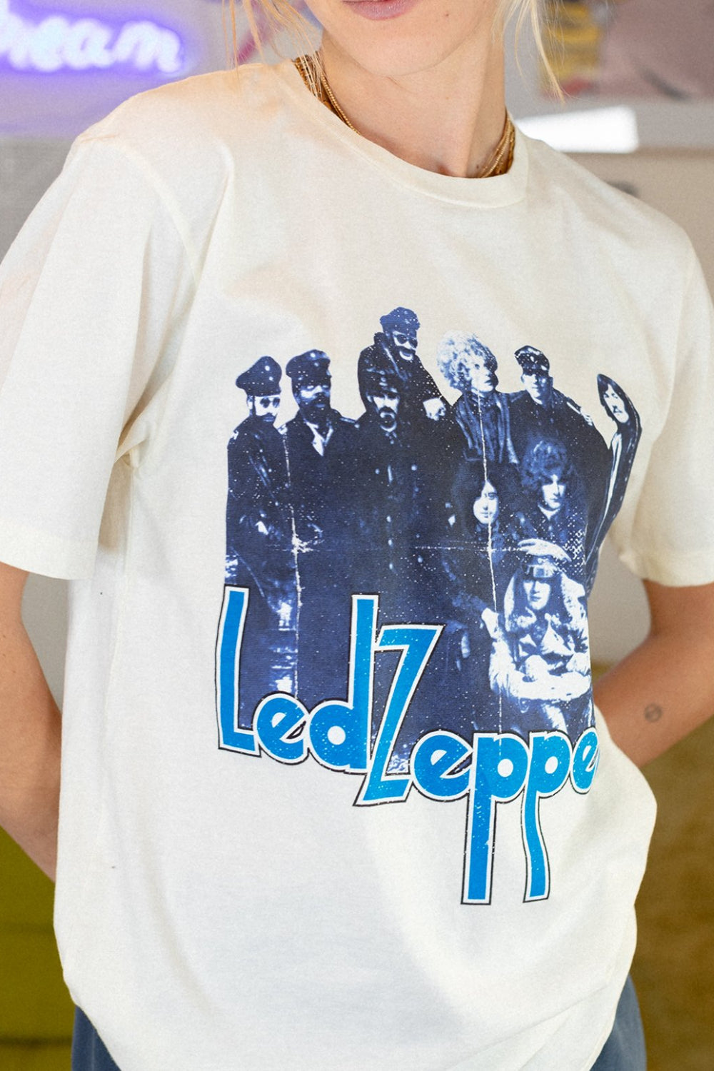 A stylish white tee shirt featuring a Led Zeppelin graphic, designed for unisex fit with a classic crewneck.