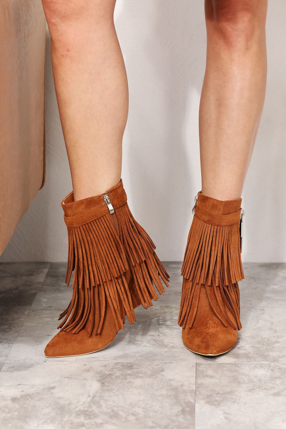 Legend Women's Tassel Wedge Heel Ankle Booties featuring an open shank design, pointy toe, and stylish tassels in premium vegan suede.