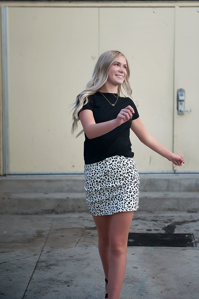 Black and white leopard mini skirt displayed on a mannequin, showcasing its stylish design and comfortable fit.