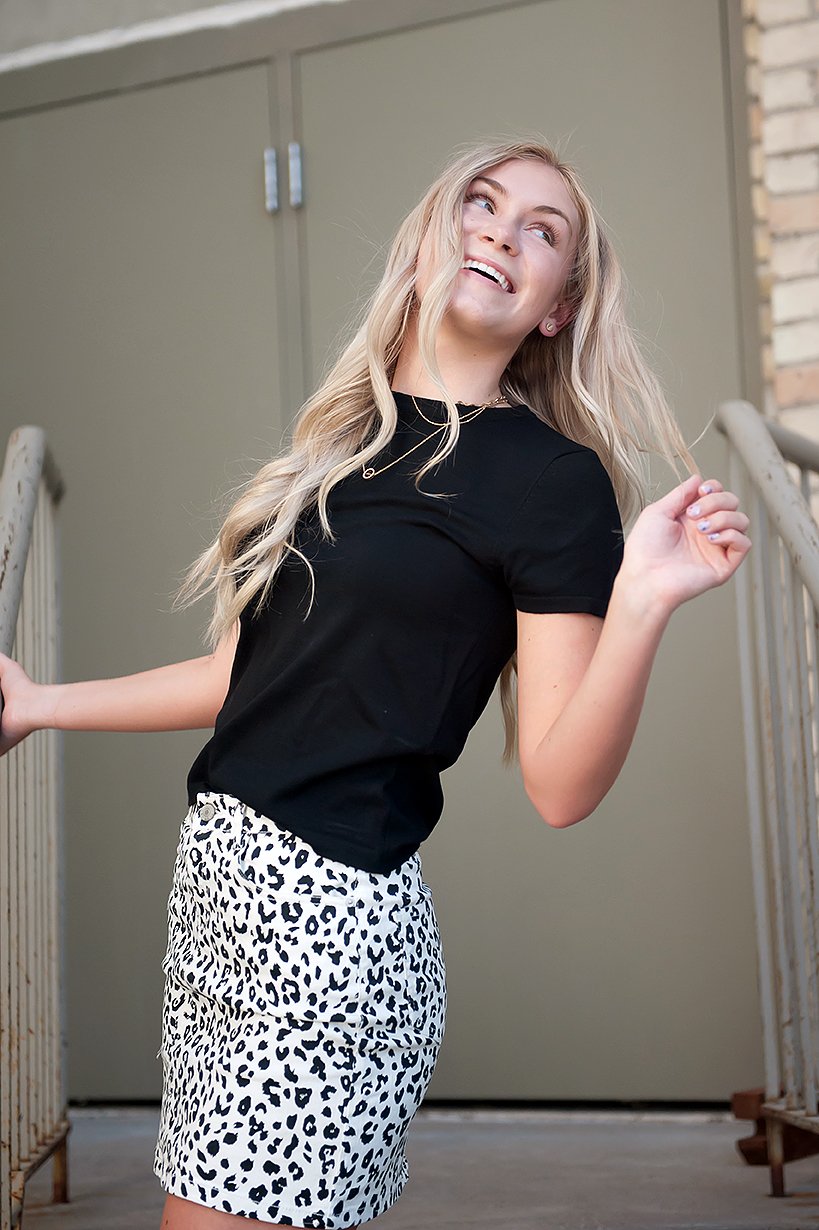 Black and white leopard mini skirt displayed on a mannequin, showcasing its stylish design and comfortable fit.