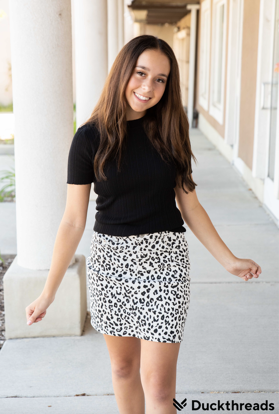 Black and white leopard mini skirt displayed on a mannequin, showcasing its stylish design and comfortable fit.