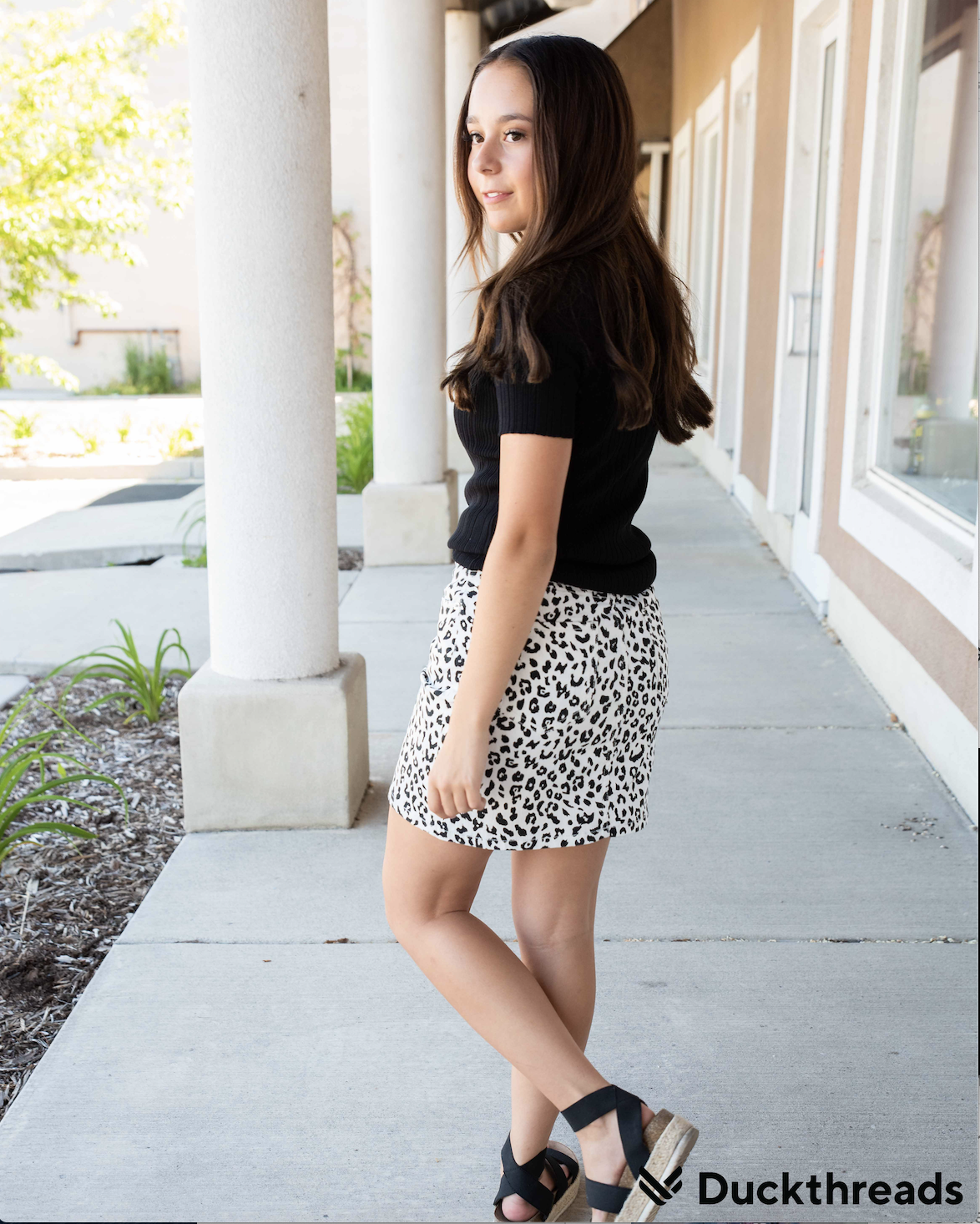 Black and white leopard mini skirt displayed on a mannequin, showcasing its stylish design and comfortable fit.