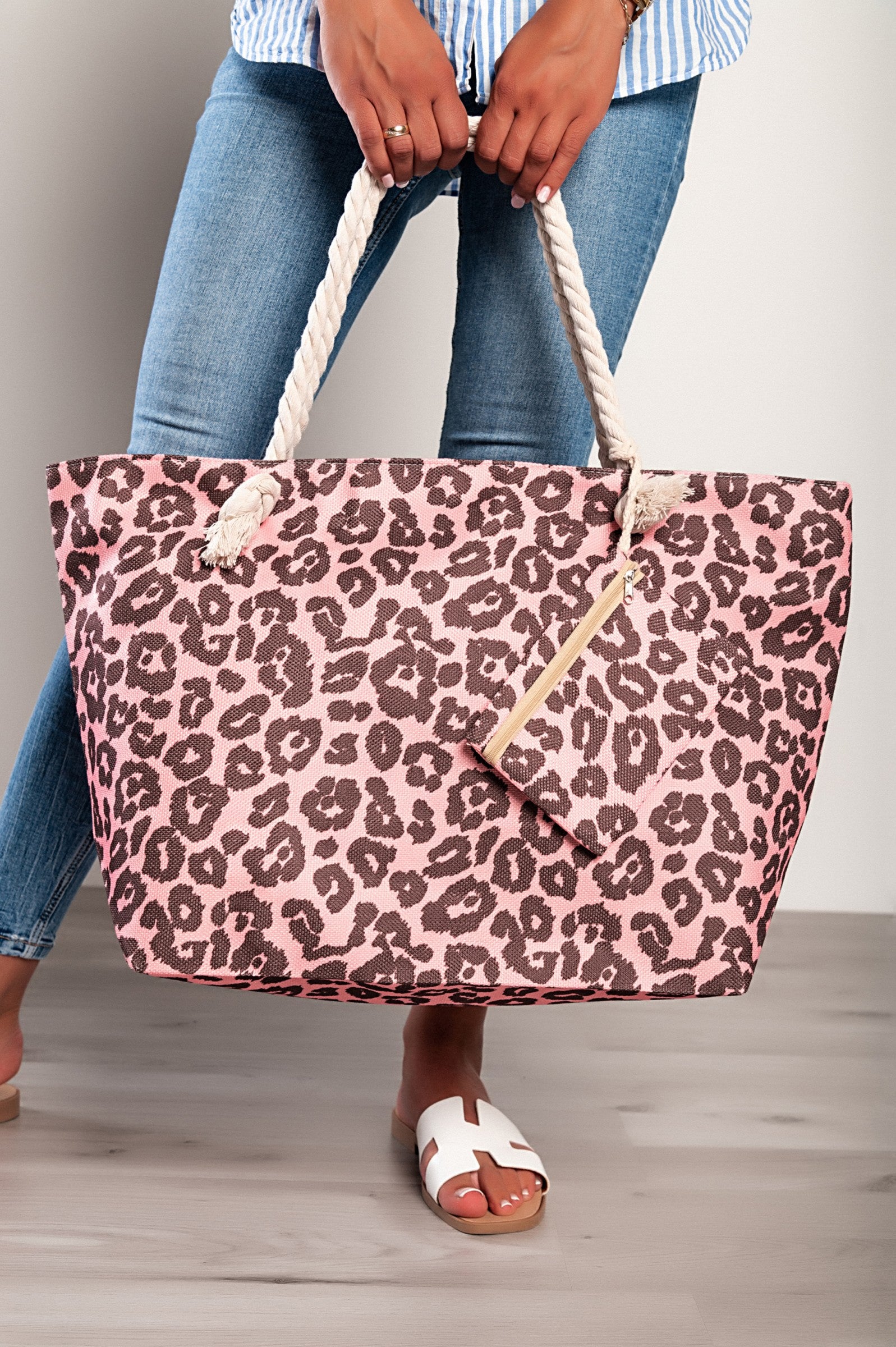 Light pink leopard print beach bag with braided handles and zip closure, featuring an inside pocket and a small matching bag.