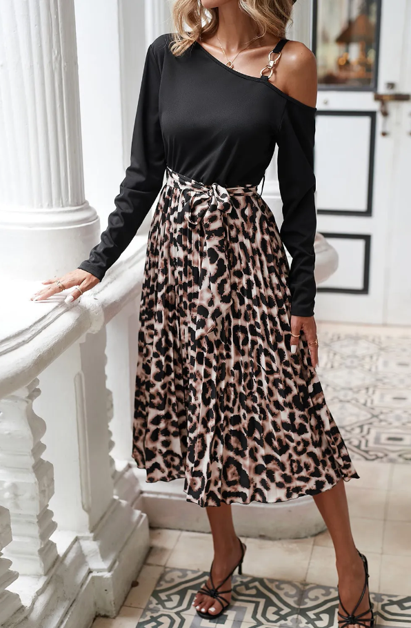 A stylish black leopard print midi dress featuring an asymmetrical neckline, long sleeves, and a decorative belt, perfect for various occasions.