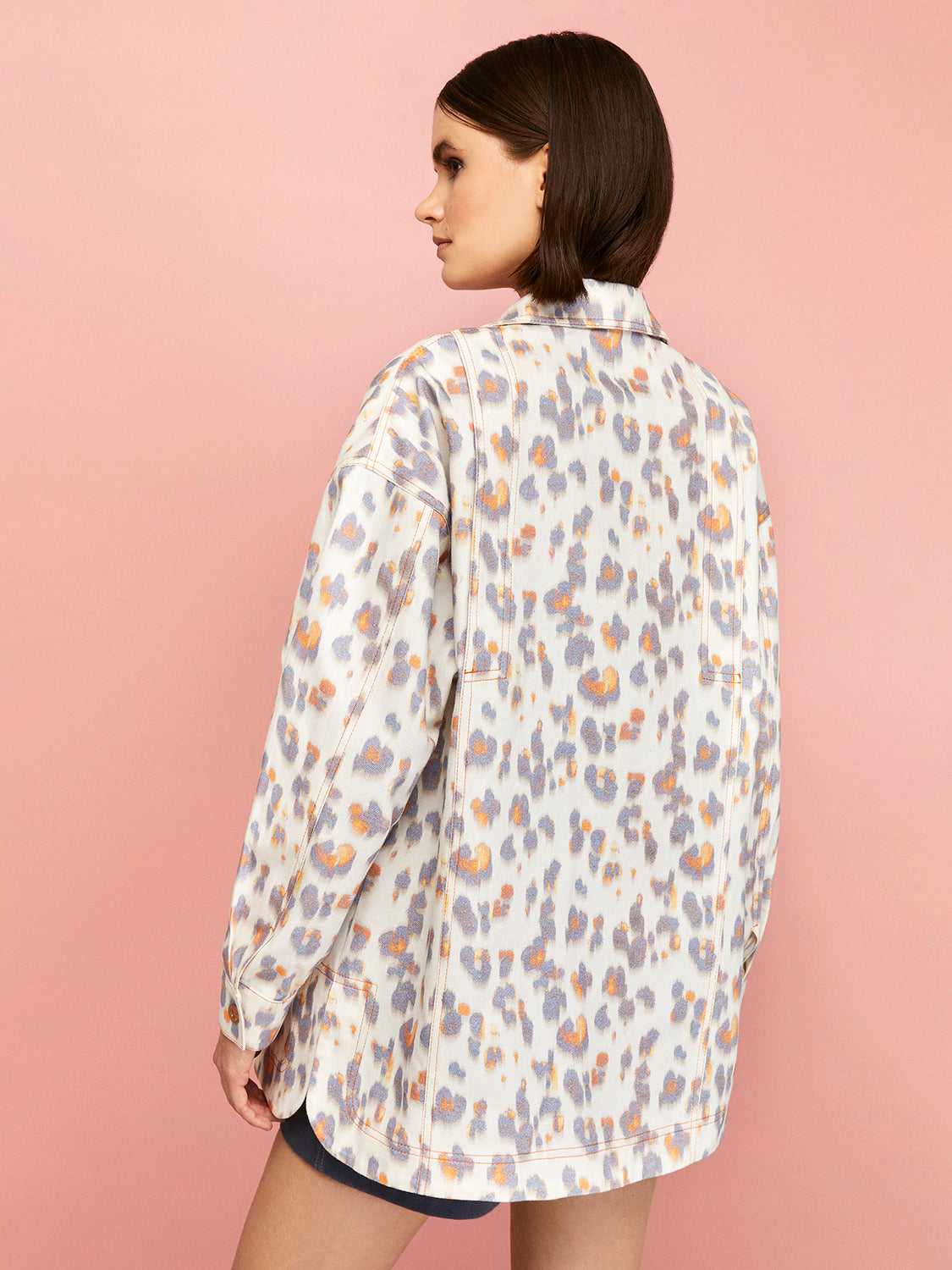 Leopard Print Oversized Denim Jacket featuring a lapel collar, long sleeves, and multiple pockets in a stylish design.