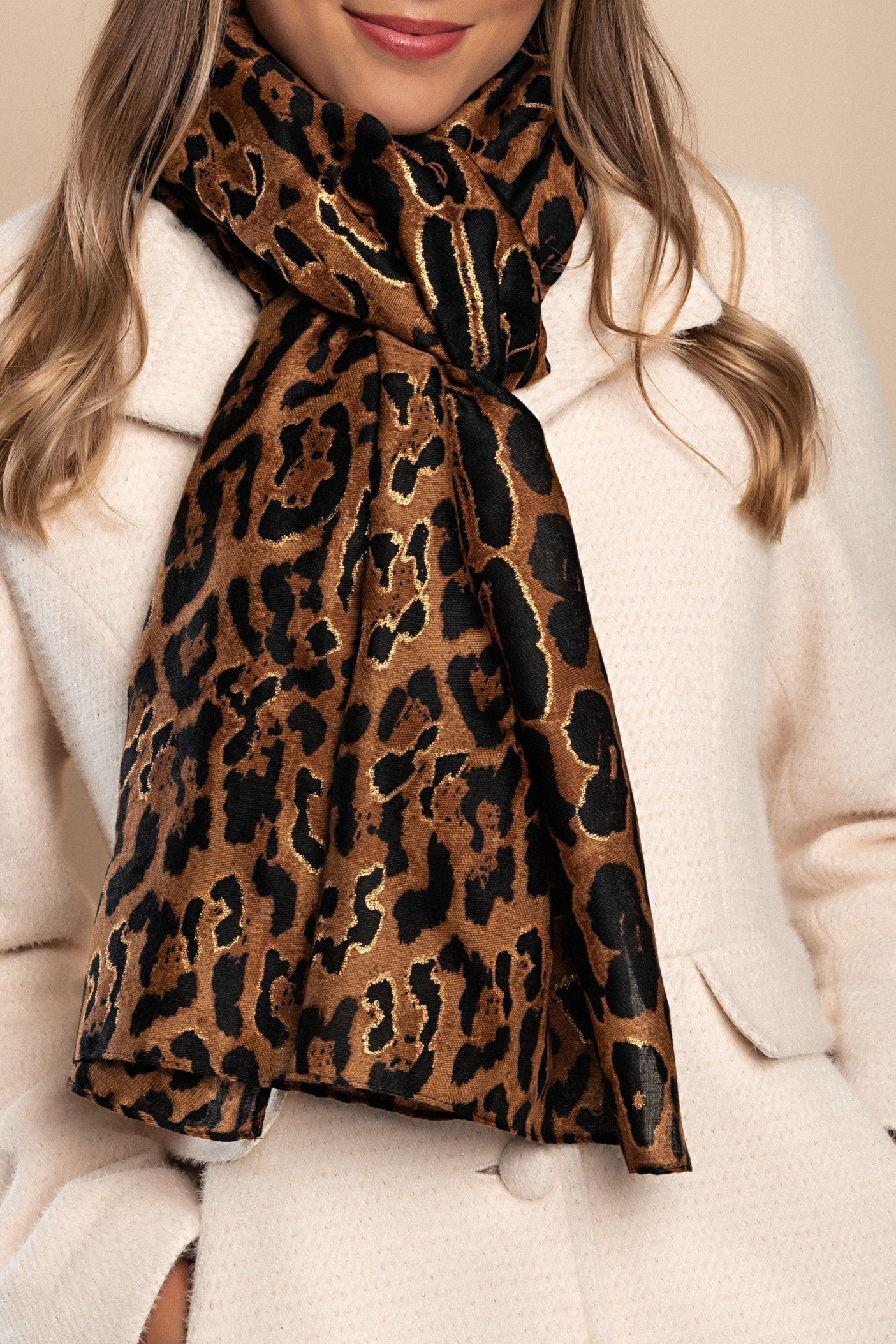 Elegant brown leopard print scarf made from a soft viscose and cotton blend, showcasing a stylish design.