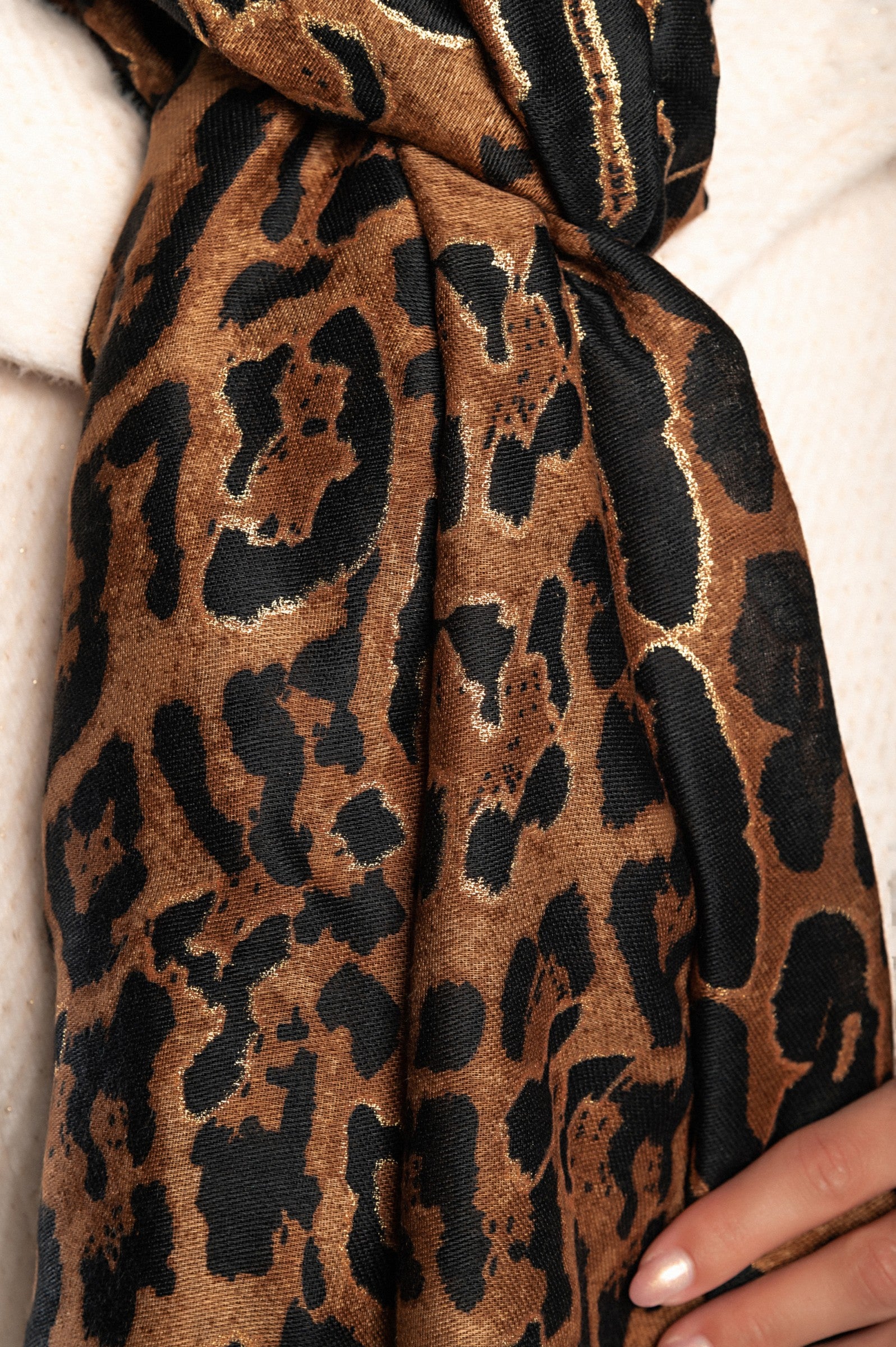 Elegant brown leopard print scarf made of viscose and cotton blend, showcasing a stylish design.