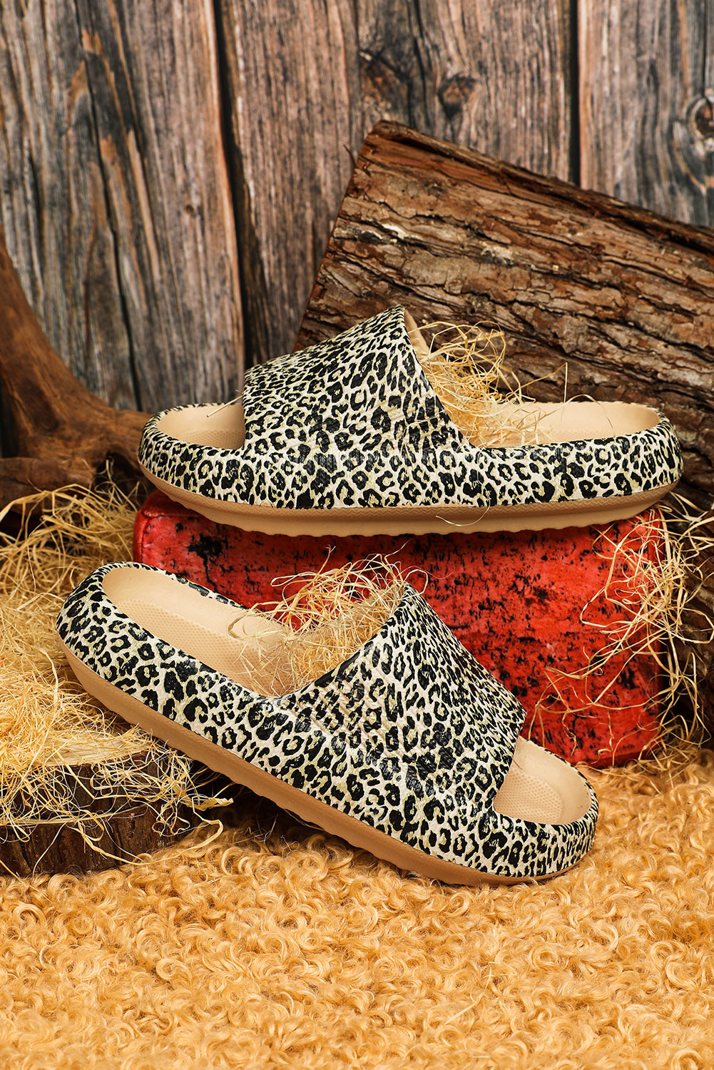 A pair of stylish leopard print soft rubber slippers designed for women, featuring a breathable hollow side and thick sole for comfort.