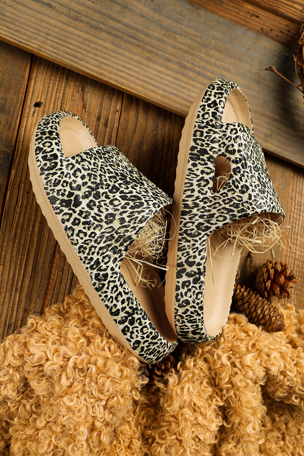 A pair of stylish leopard print soft rubber slippers designed for women, featuring a breathable hollow side and thick sole for comfort.