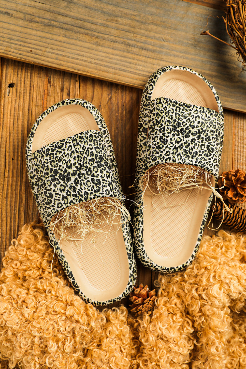 A pair of stylish leopard print soft rubber slippers designed for women, featuring a breathable hollow side and thick sole for comfort.