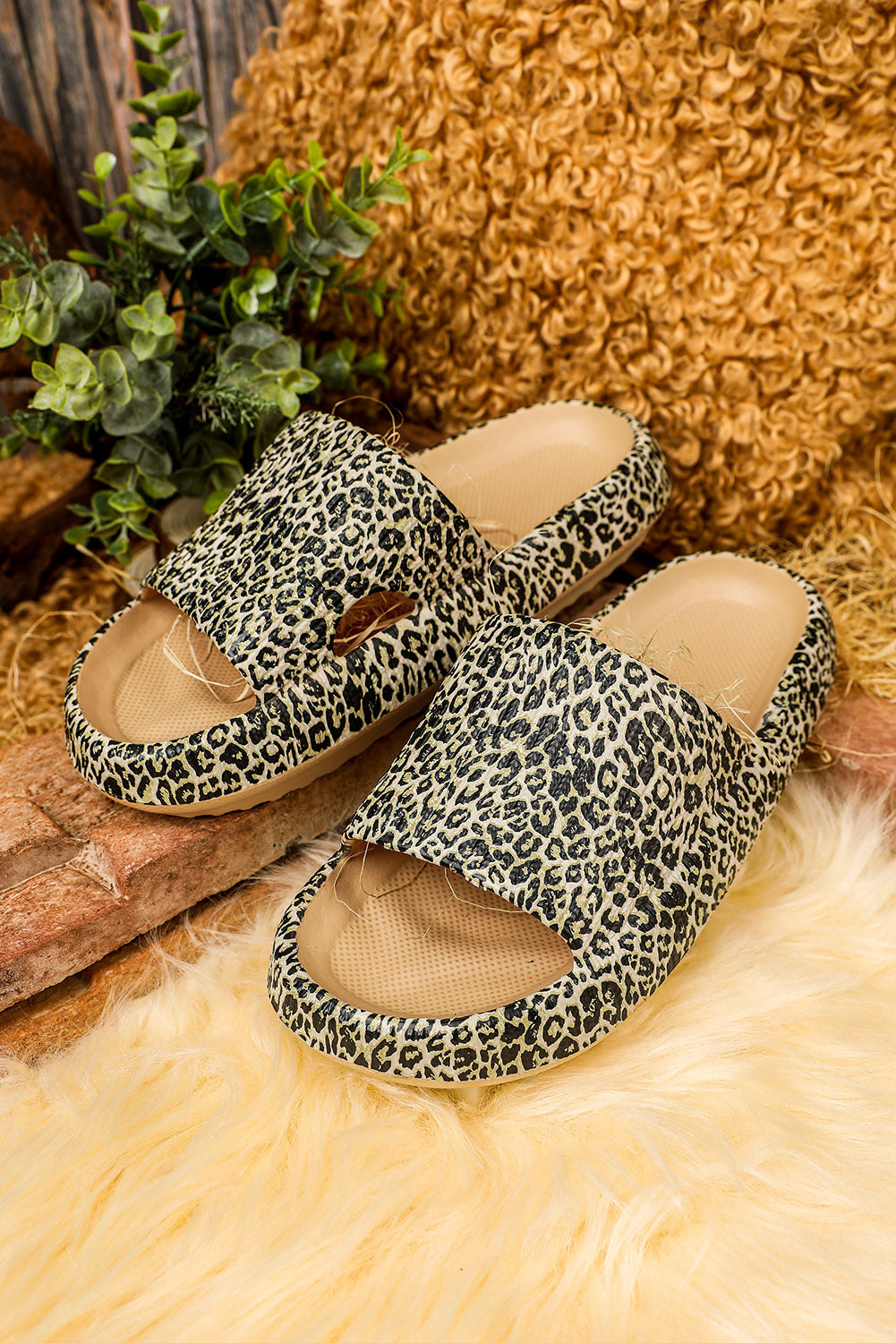 A pair of stylish leopard print soft rubber slippers designed for women, featuring a breathable hollow side and thick sole for comfort.