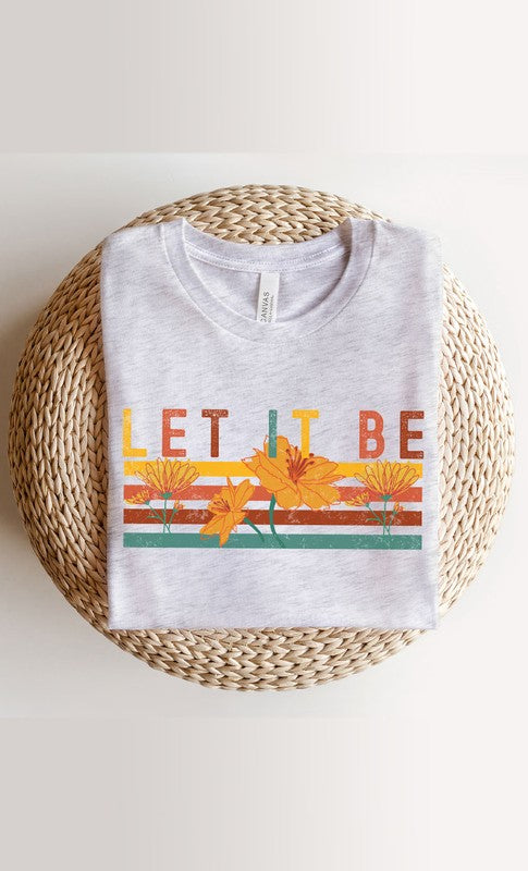 Let It Be Graphic Tee PLUS in white and cream colors, showcasing a stylish graphic design, perfect for casual wear.