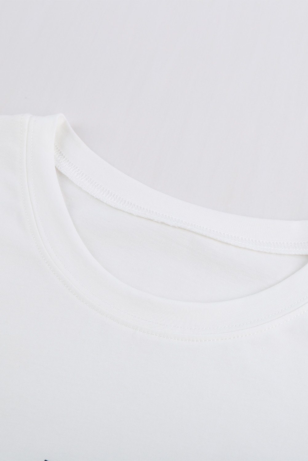 A pure white short sleeve tee featuring a stylish letter print, perfect for summer wear.