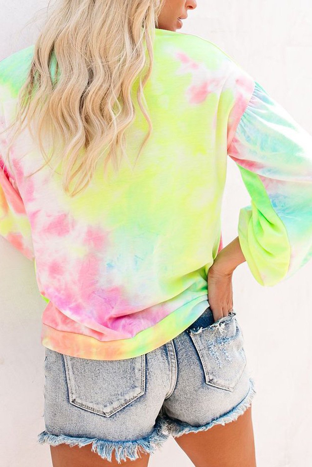 A vibrant multicolor tie-dye sweatshirt featuring a trendy letters graphic print on the front, showcasing a relaxed fit and drop sleeves design.