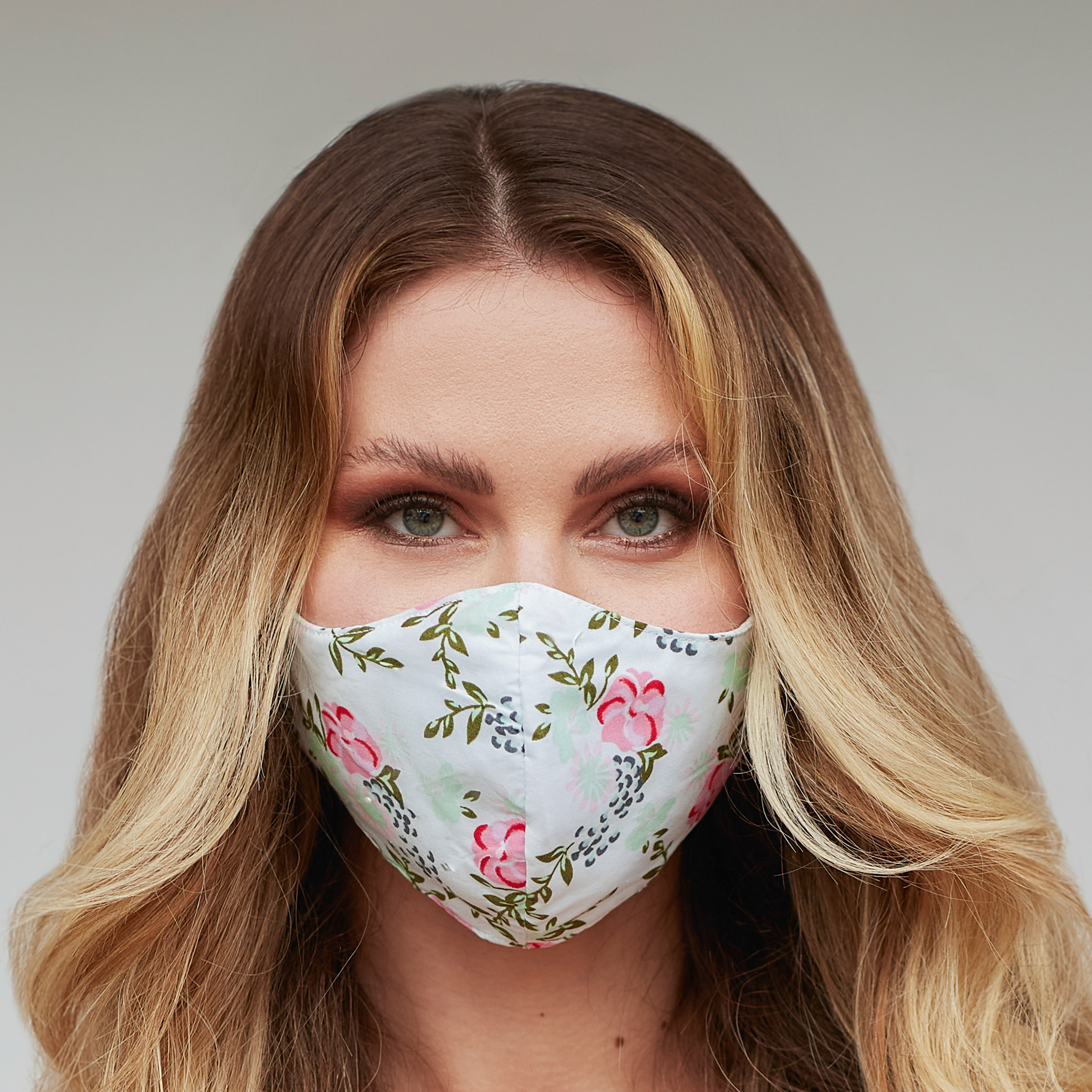 Light green floral face mask featuring a unique design with vibrant floral patterns, perfect for style and protection.