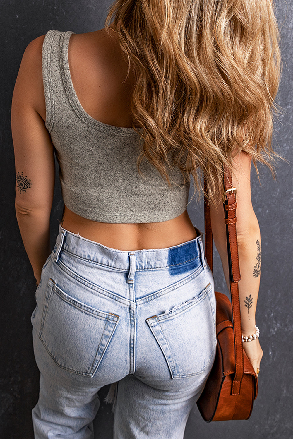 Light grey stretchy knitted sleeveless U neck crop top displayed on a mannequin, showcasing its elegant design and comfortable fit.