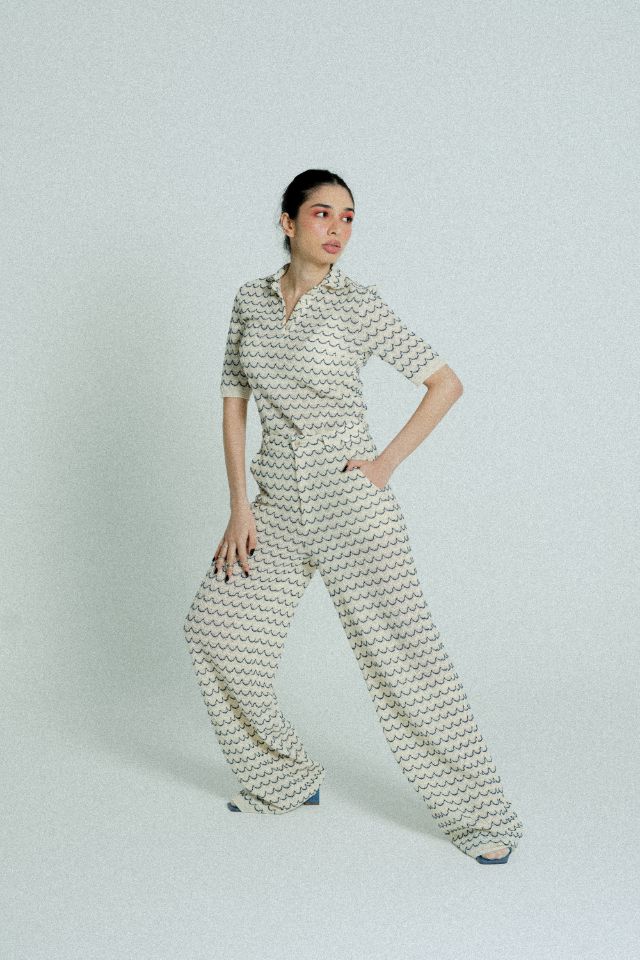 Light Weight Cotton Knit Long Wide Trousers in Marine with beige and marine blue wave pattern, featuring side pockets and wooden effect button.