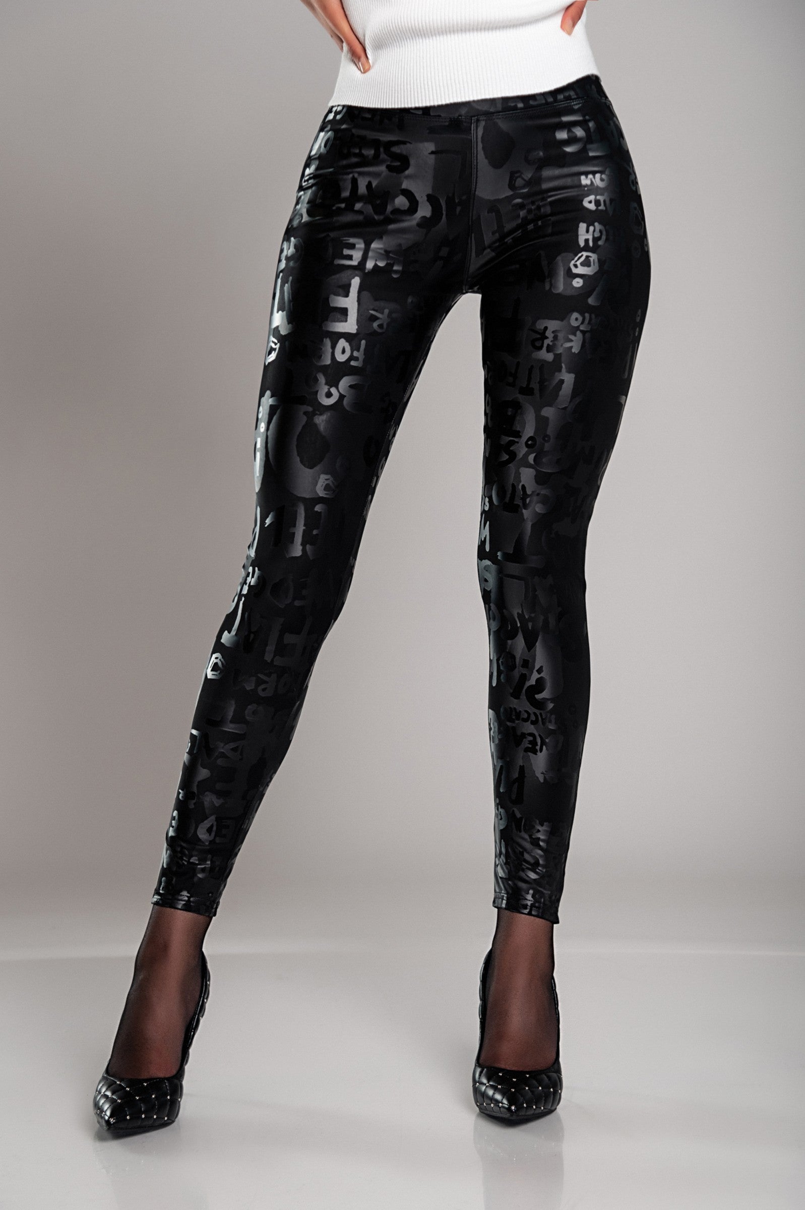 Black lined leggings with a wide waistband and fashionable letter print design, showcasing their soft and elastic fabric.