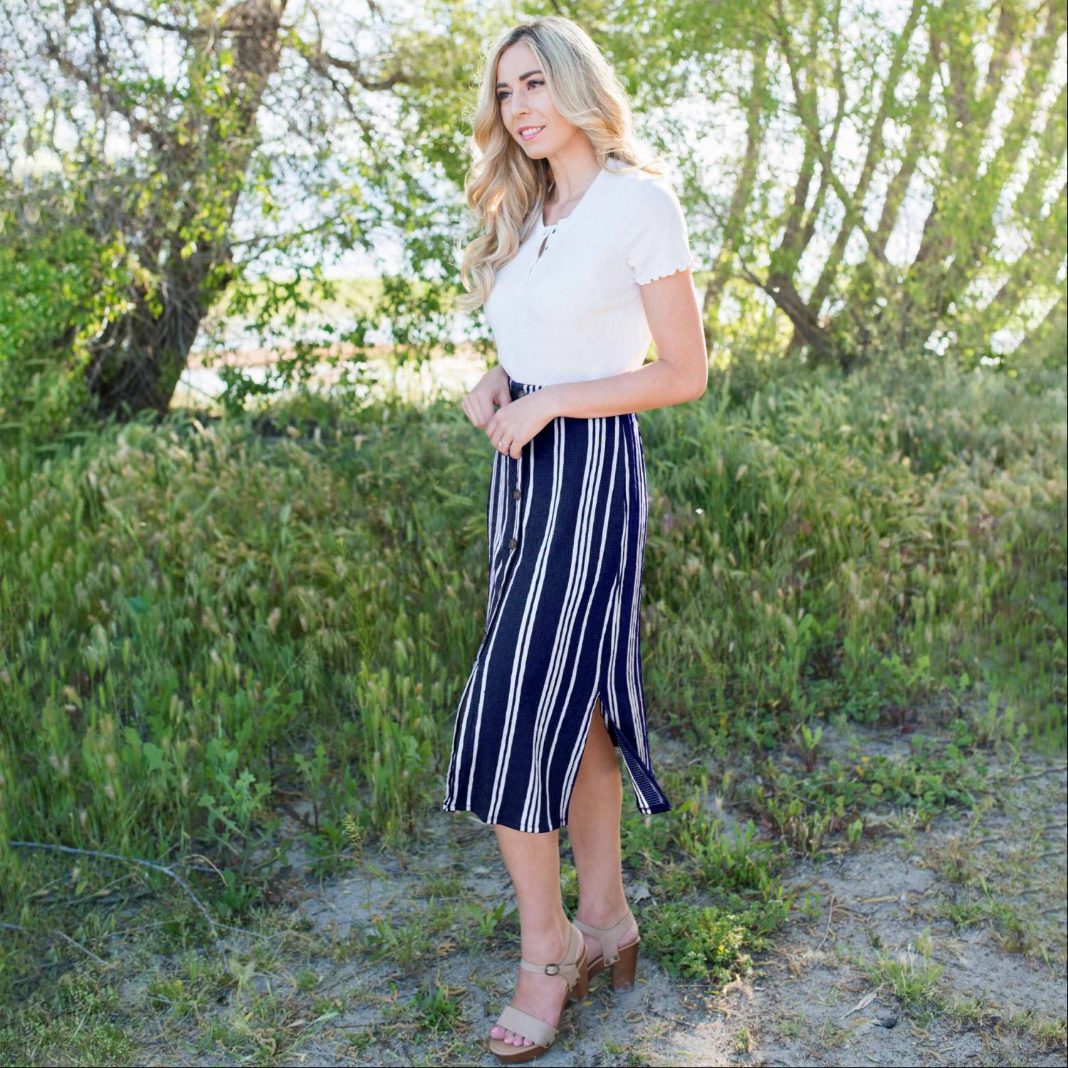 Linen Buttoned Paperbag Midi Skirt featuring a trendy striped design, mid-thigh button-down style, and comfortable paperbag waist.