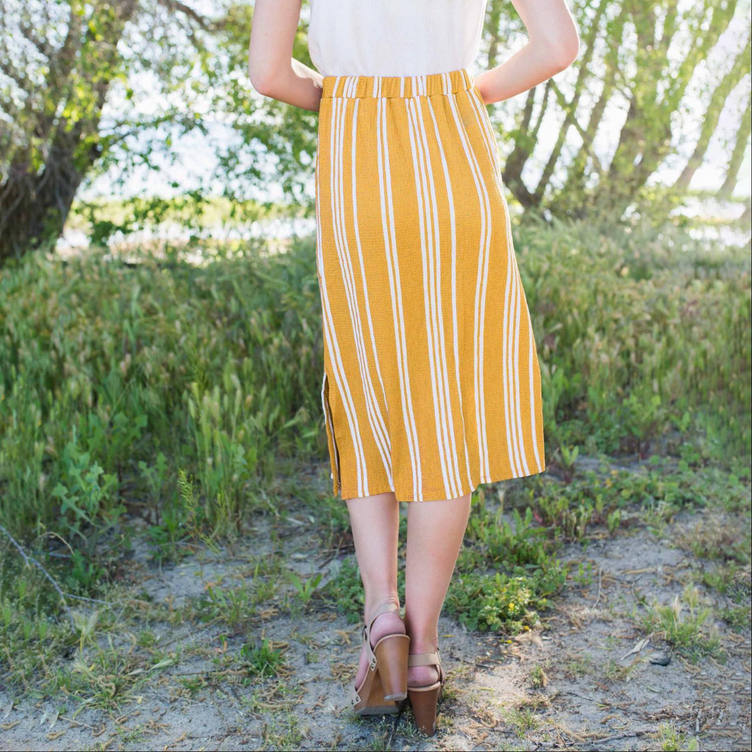 Linen Buttoned Paperbag Midi Skirt featuring a trendy striped design, mid-thigh button-down style, and comfortable paperbag waist.