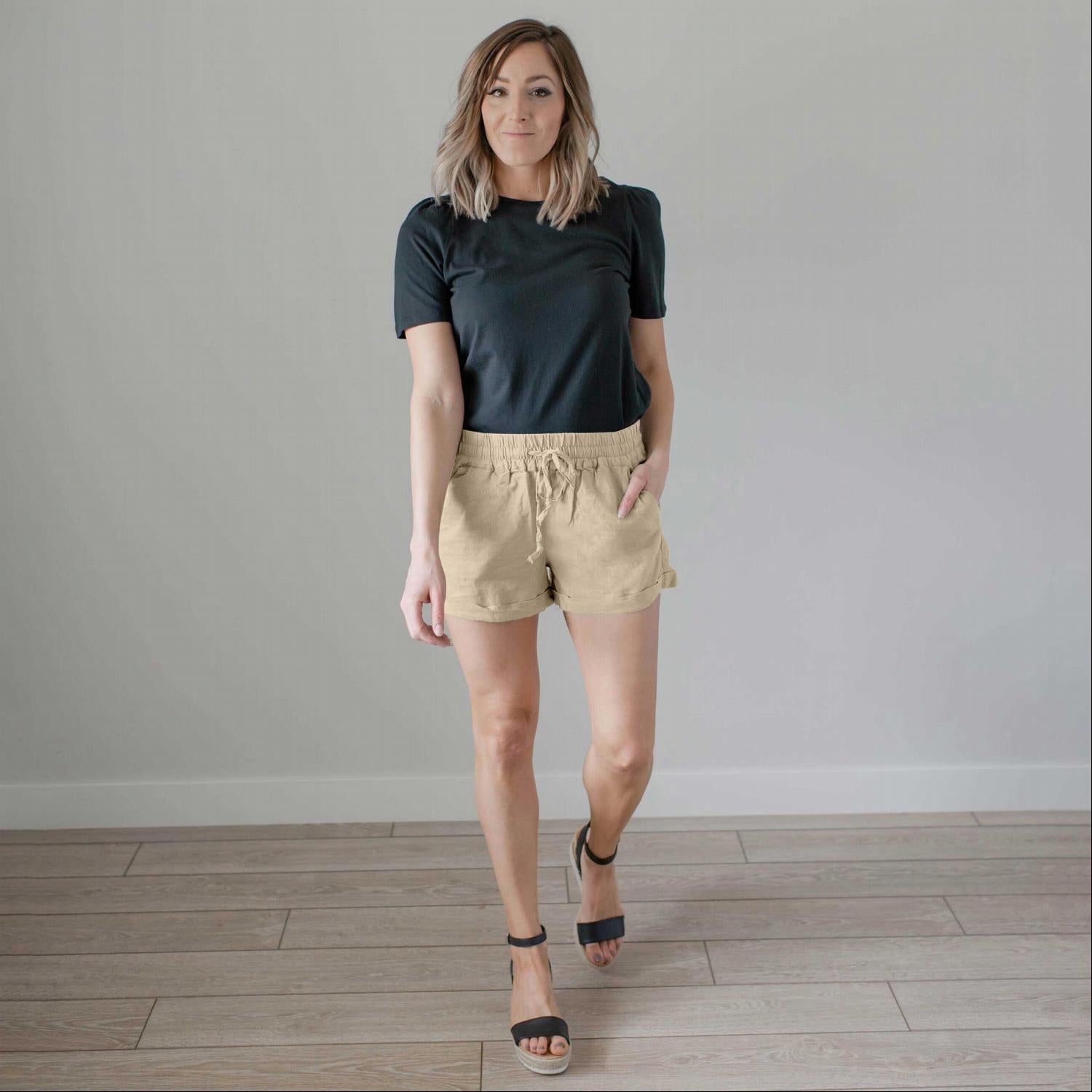 A pair of stylish linen shorts with pockets, featuring a tie front and adjustable waist, perfect for summer wear.