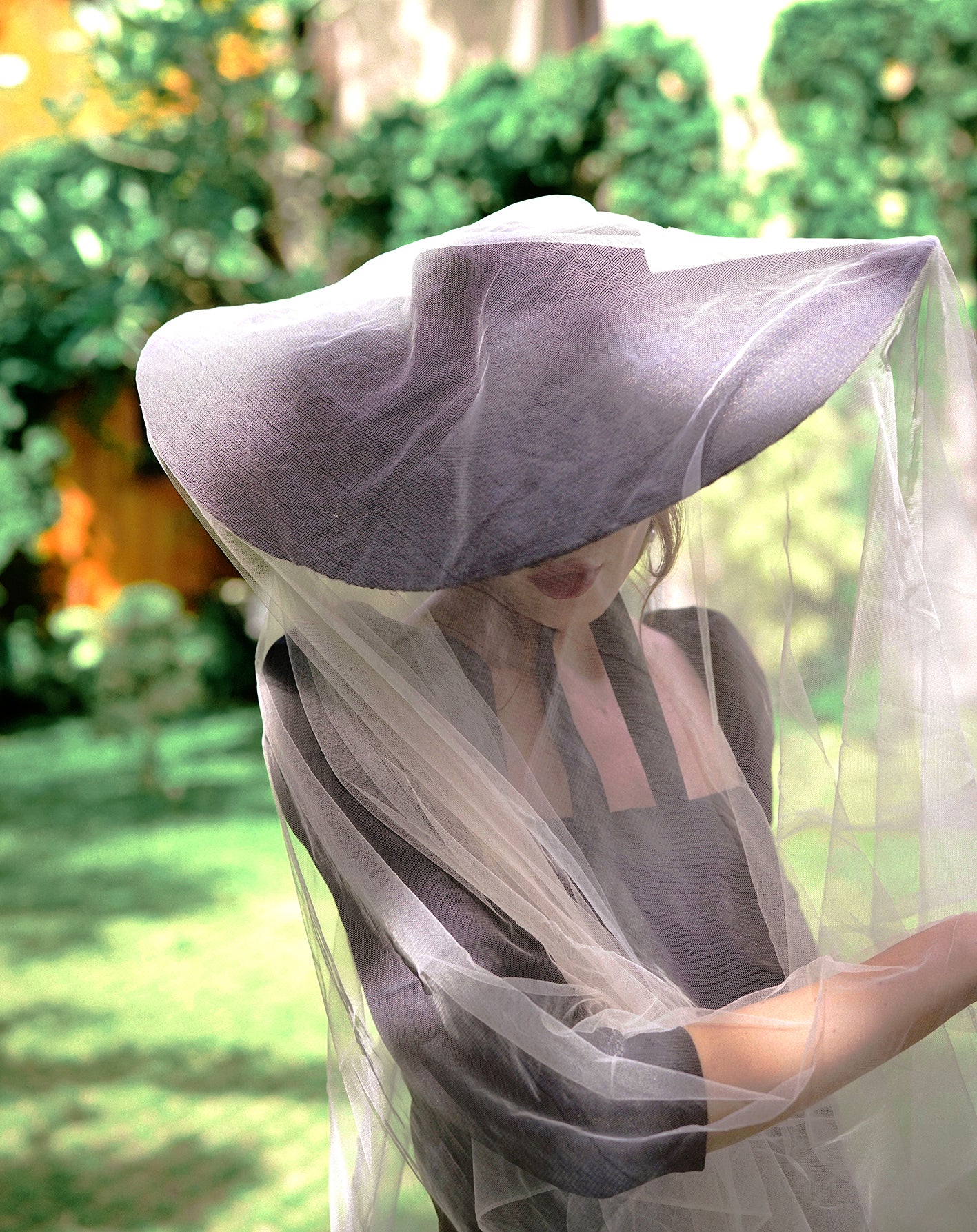 LOLA Wide Brim Jute Straw Hat in Black, showcasing its elegant design and wide brim, perfect for summer outings.