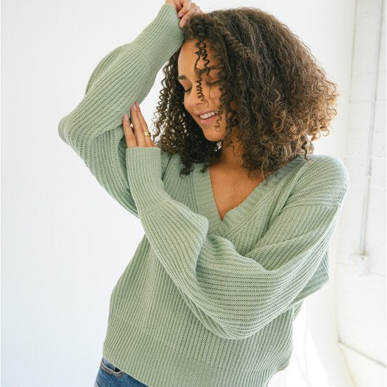 A stylish Long Balloon Sleeve Deep V-neck Sweater in three colors, featuring a plunging neckline and relaxed balloon sleeves.