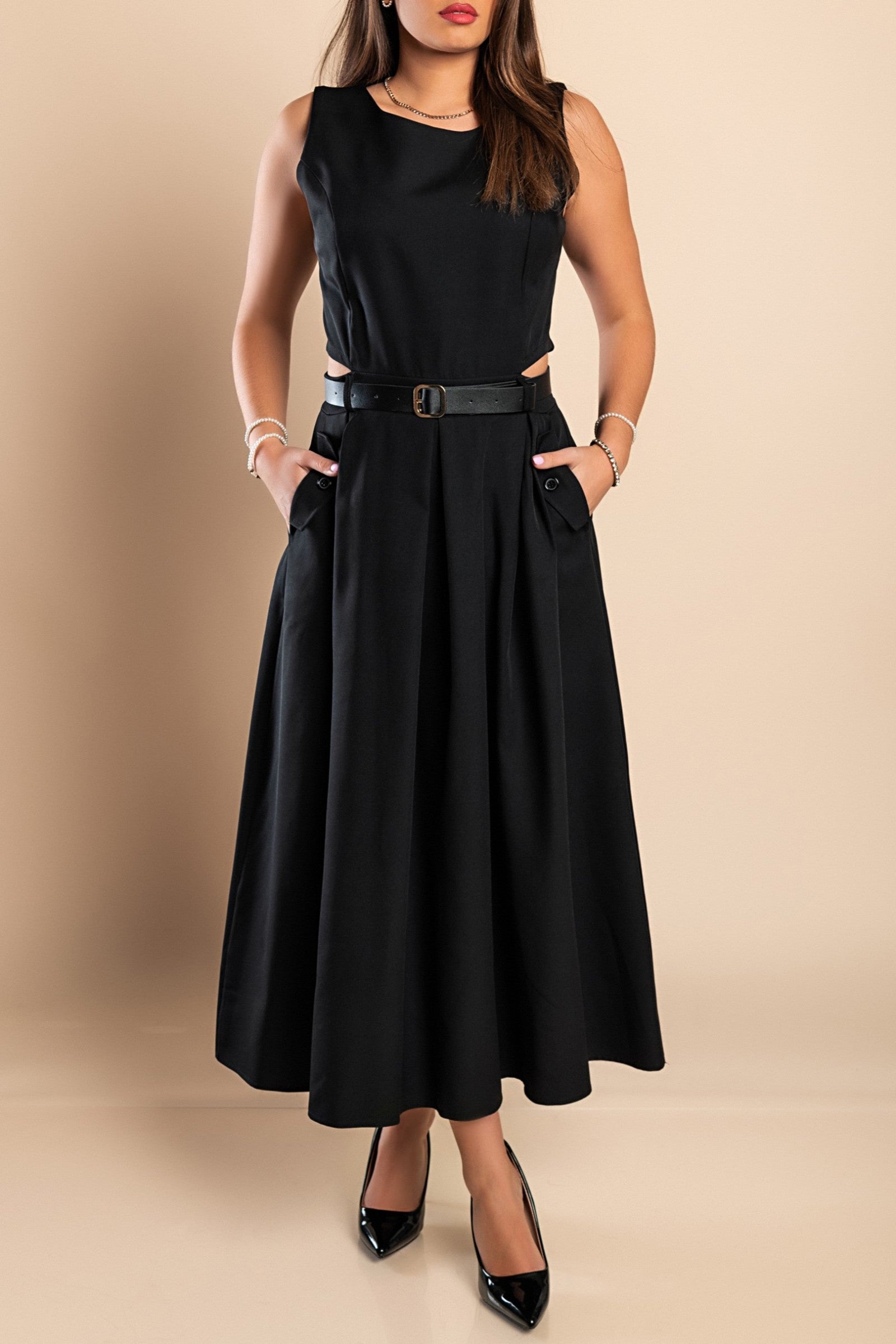 Elegant black long dress with stylish side slits and a decorative belt, showcasing a round neckline and sleeveless design.