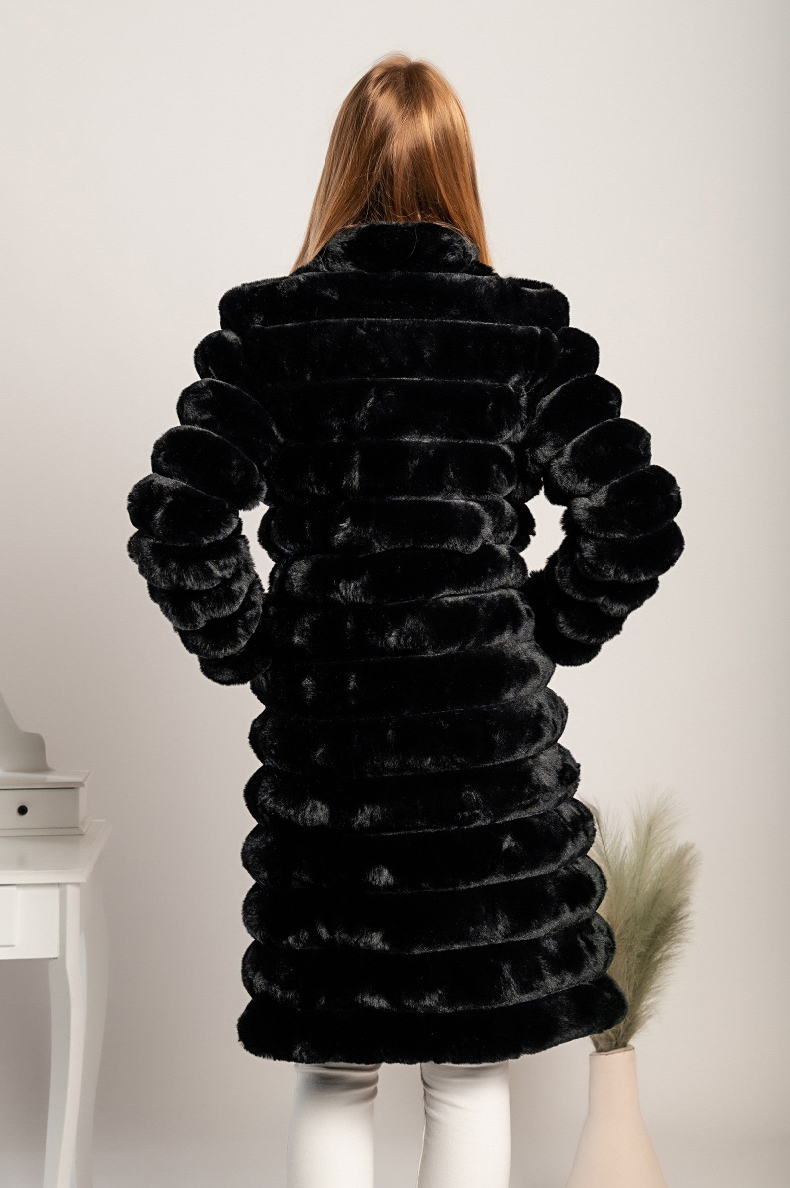 Long elegant black faux fur coat by Benimia with stand-up collar and pockets.