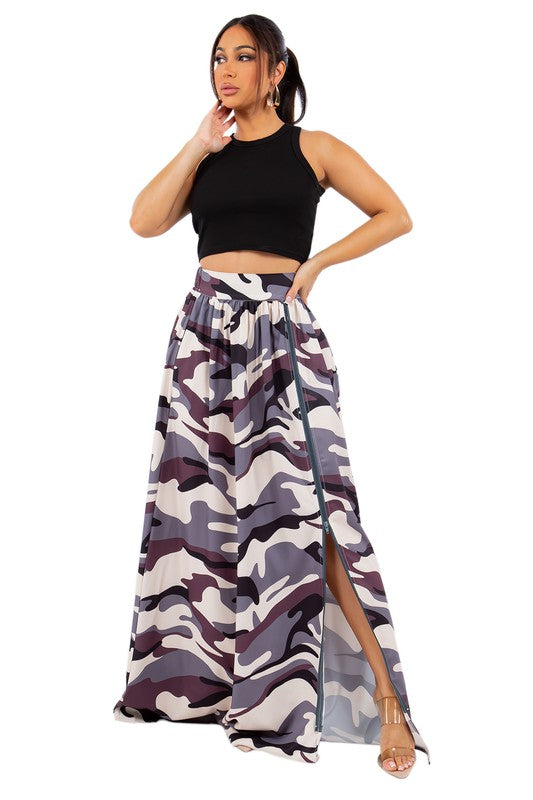 A stylish long maxi skirt featuring a front zipper and elasticized back waist, displayed on a model.