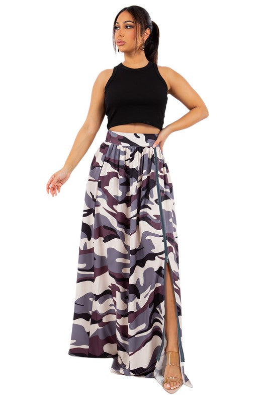 A stylish long maxi skirt featuring a front zipper and elasticized back waist, displayed on a model.