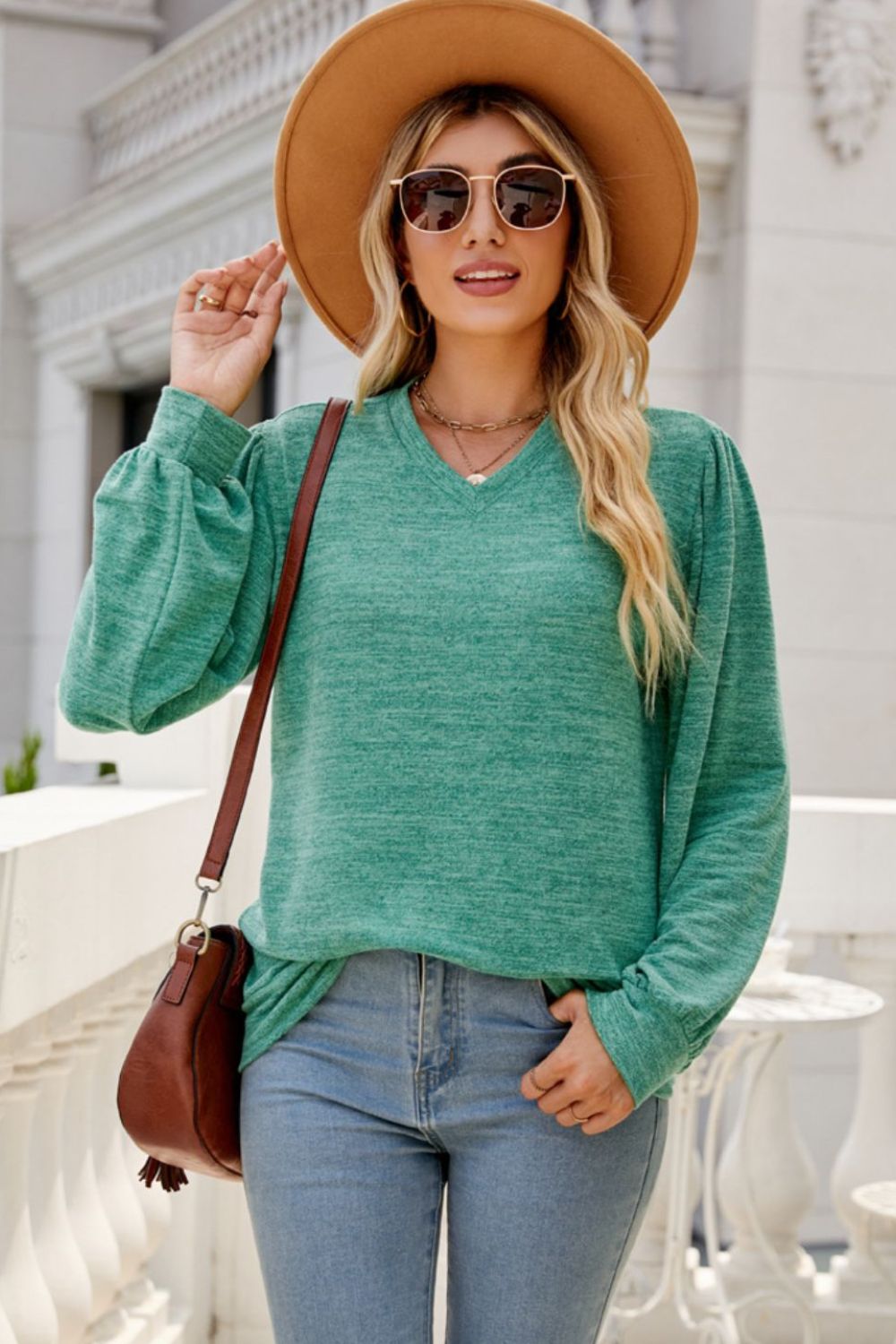 A stylish Long Puff Sleeve V-Neck Top in a solid color, showcasing its elegant puff sleeves and flattering neckline.