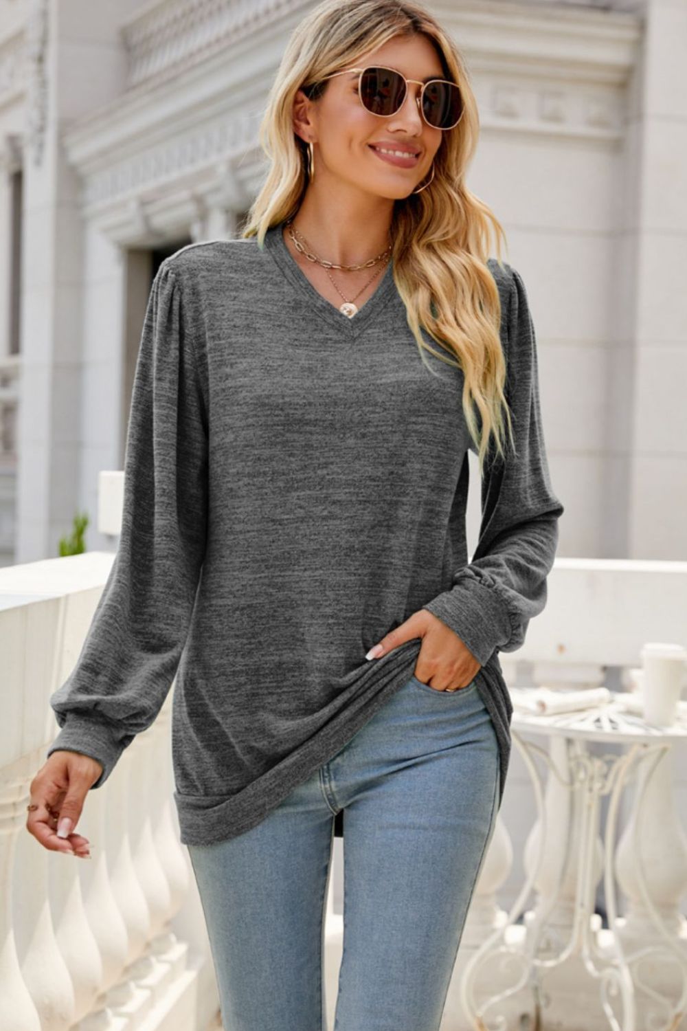 A stylish Long Puff Sleeve V-Neck Top in a solid color, showcasing its elegant puff sleeves and flattering neckline.