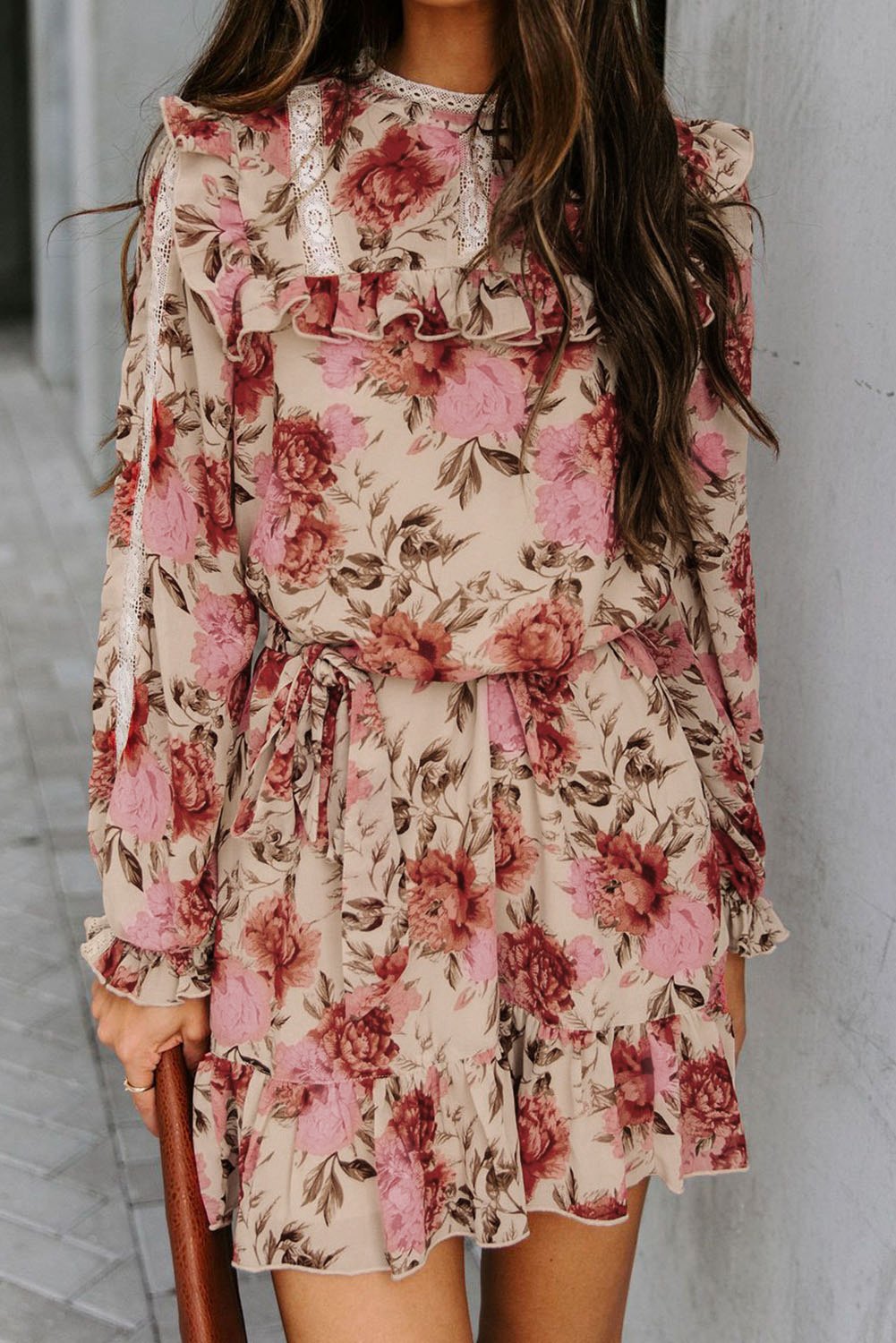 A stylish long sleeve floral dress featuring ruffles, a waist tie, and side pockets, perfect for casual and formal occasions.