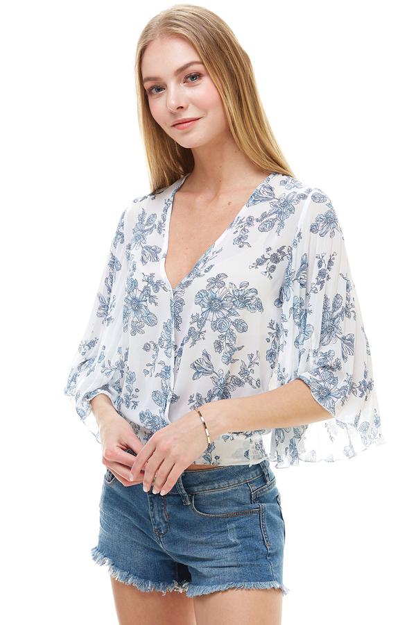 A stylish long sleeve surplice floral top featuring a deep V neckline and tie back design, perfect for casual and formal occasions.