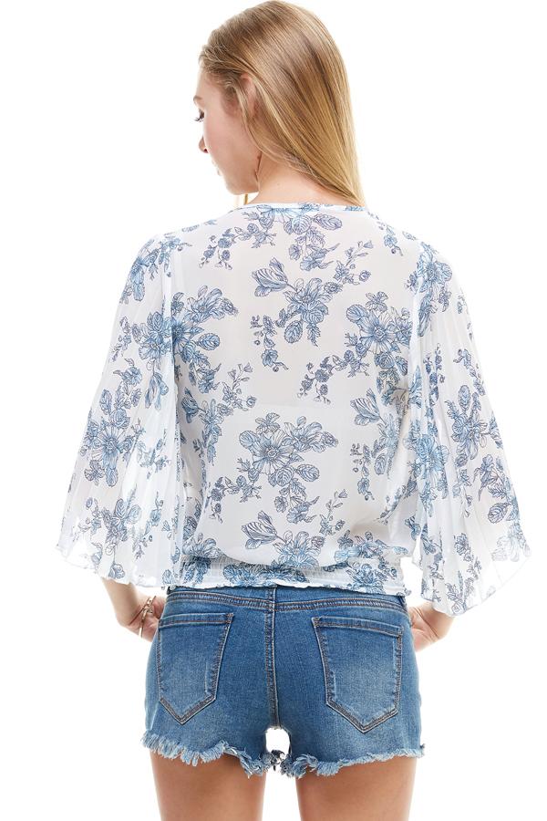 A stylish long sleeve surplice floral top featuring a deep V neckline and tie back design, perfect for casual and formal occasions.