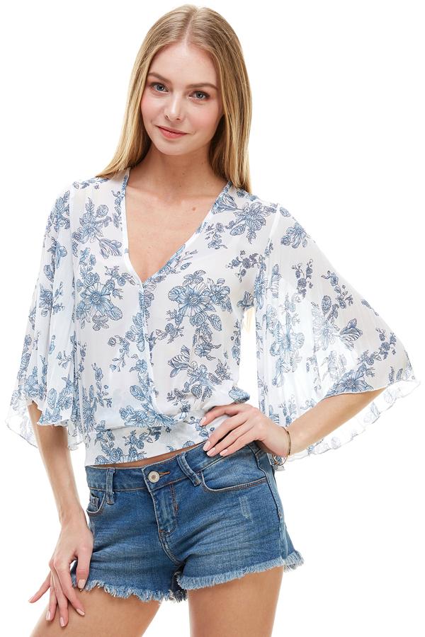 A stylish long sleeve surplice floral top featuring a deep V neckline and tie back design, perfect for casual and formal occasions.