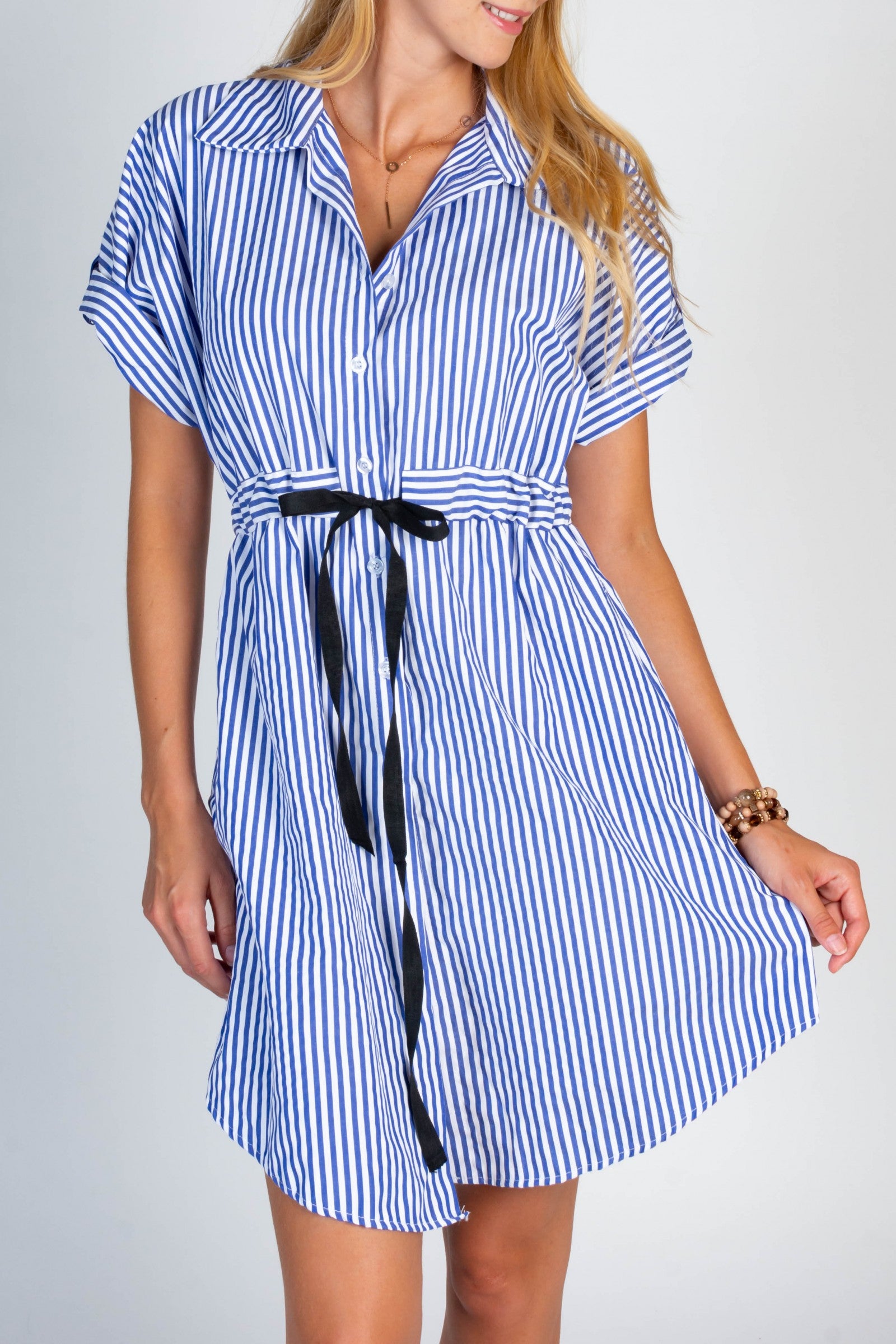 Loose-fitting mini dress featuring a deep neckline, classic collar, and stylish striped pattern, perfect for various occasions.