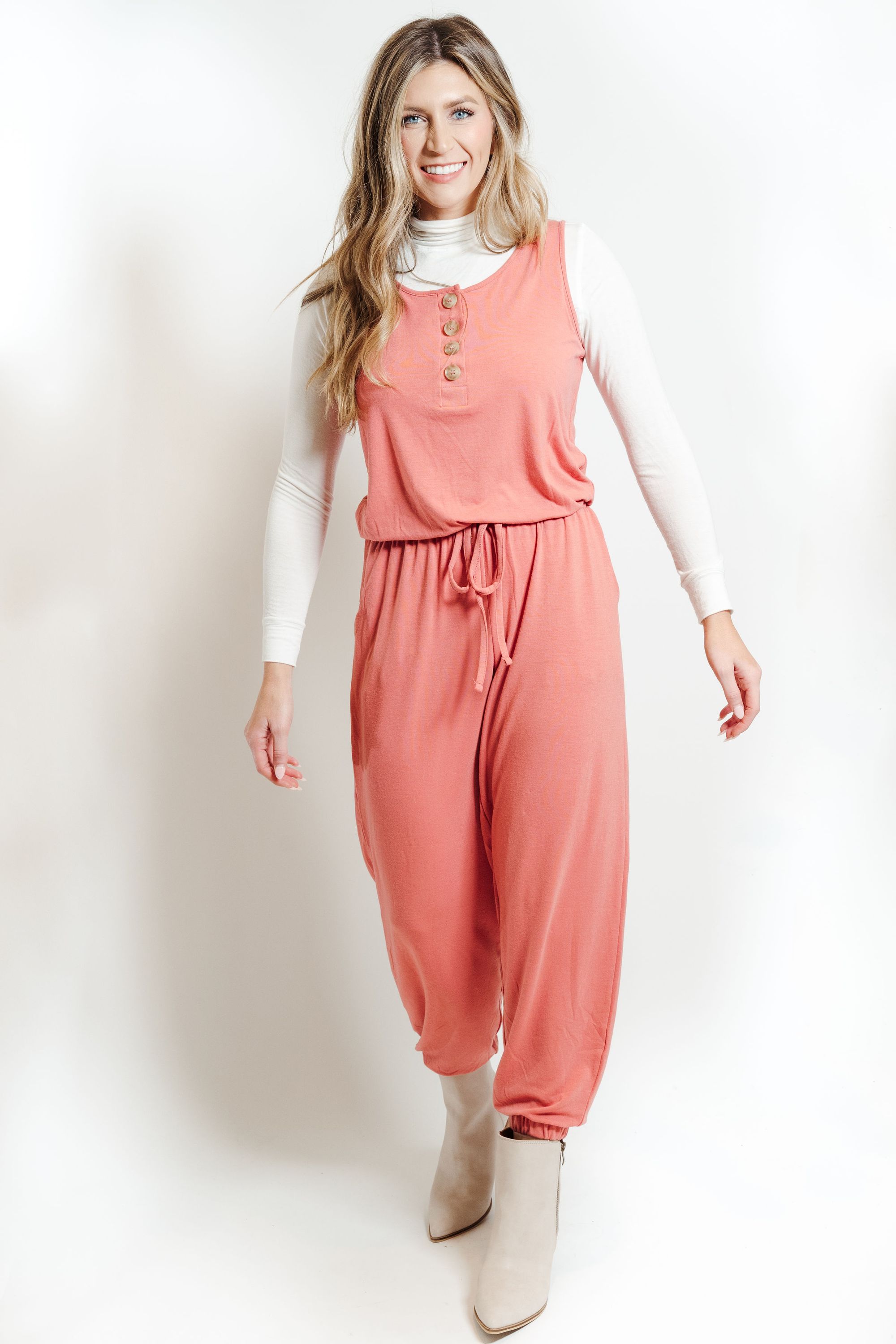 A stylish ash rose lounge jumpsuit, showcasing its soft fabric and versatile design, perfect for casual outings or lounging at home.