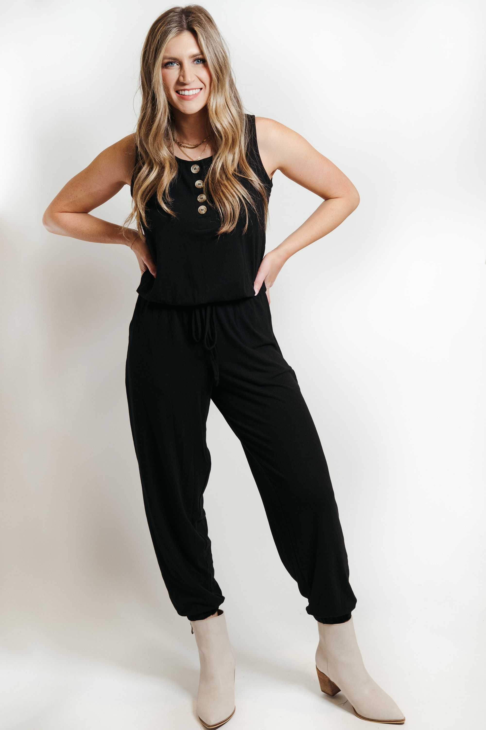 A stylish black lounge jumpsuit, perfect for casual wear or dressing up, featuring a comfortable fit and soft fabric blend.