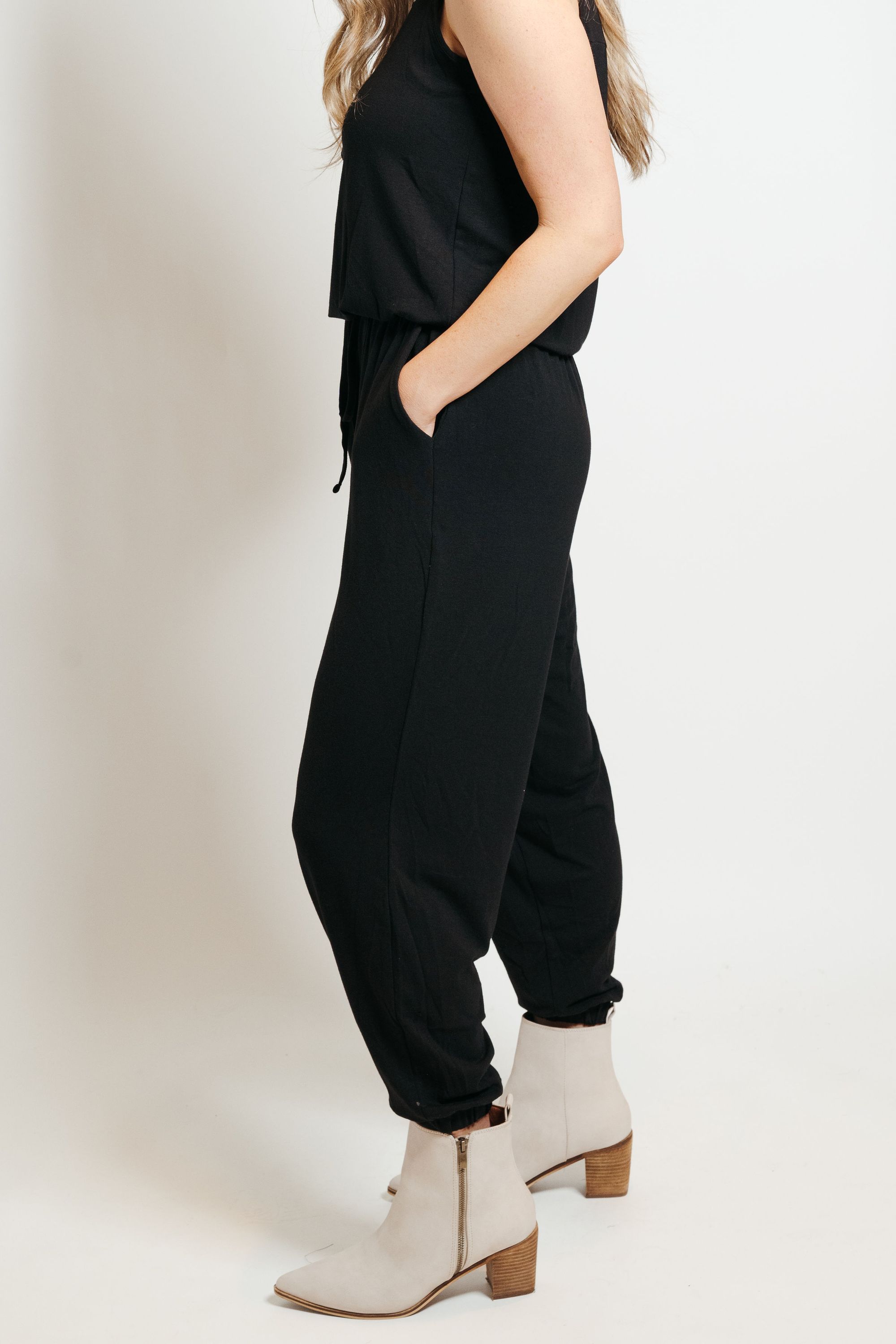 A stylish black lounge jumpsuit, perfect for casual wear or dressing up, featuring a comfortable fit and soft fabric blend.